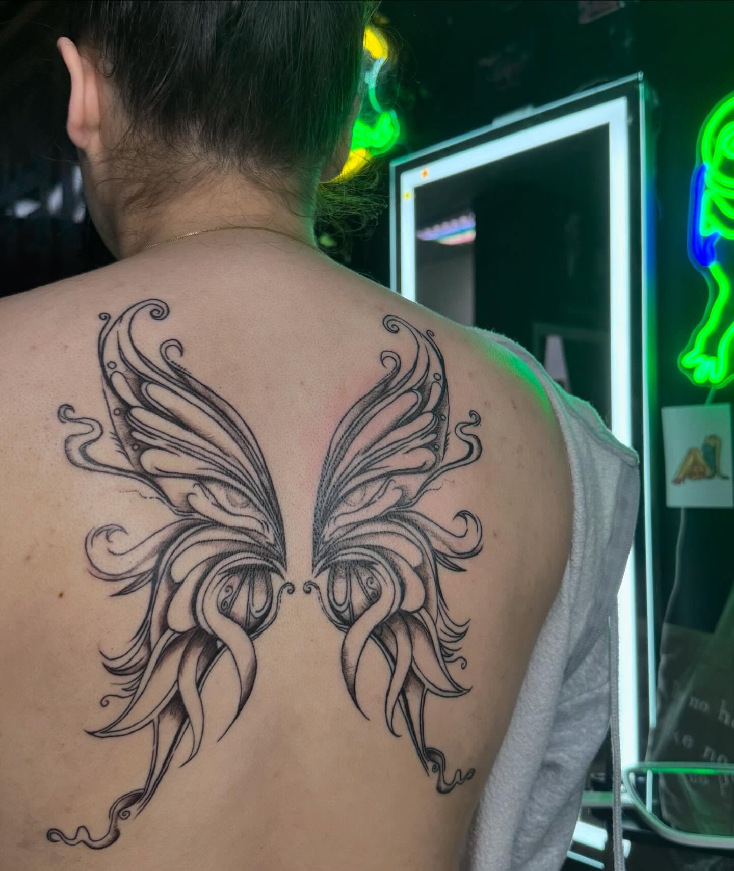 Wings ornamental tattoo on the back by Nina Rush