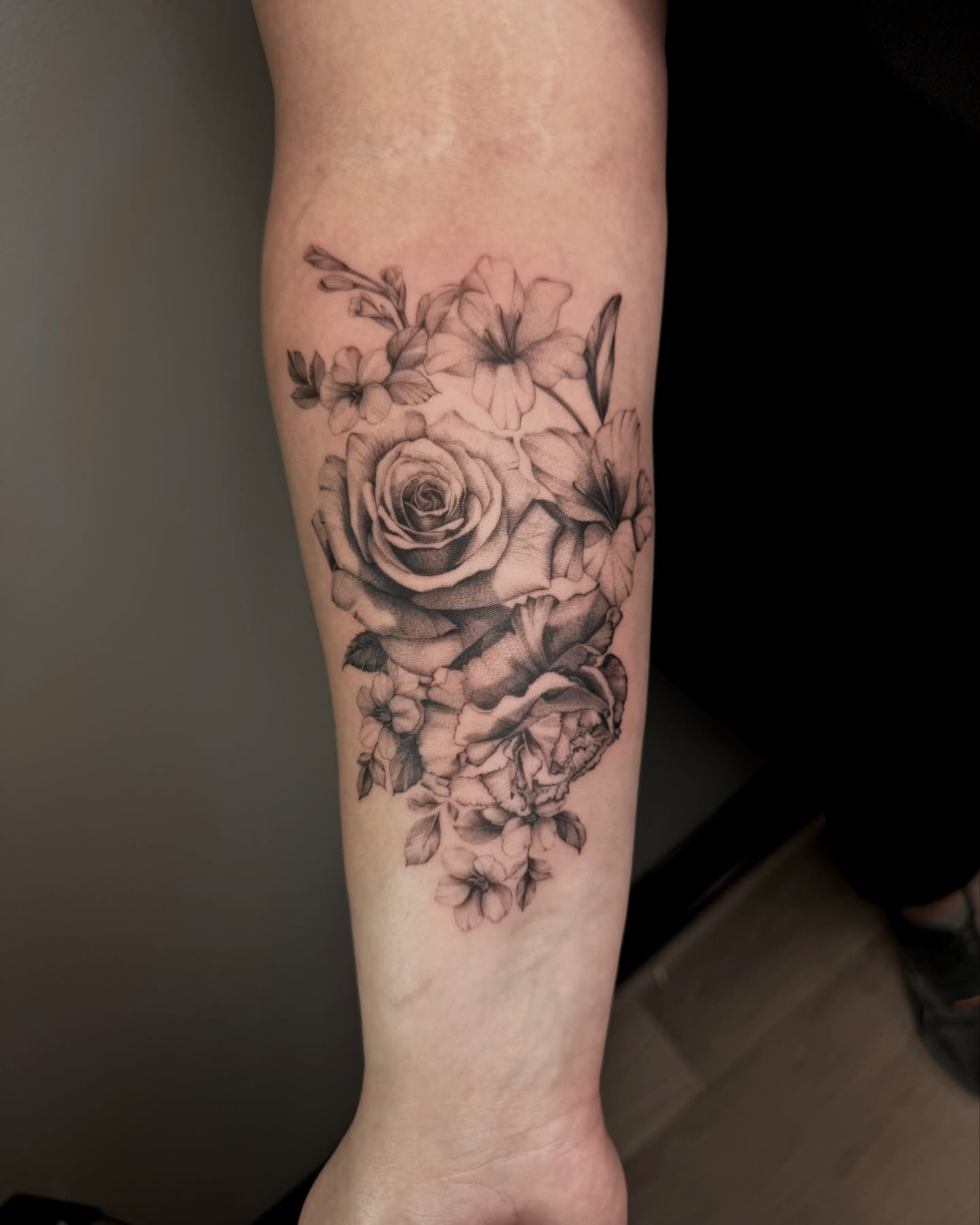 Floral bouquet realism tattoo on the forearm by Ninna