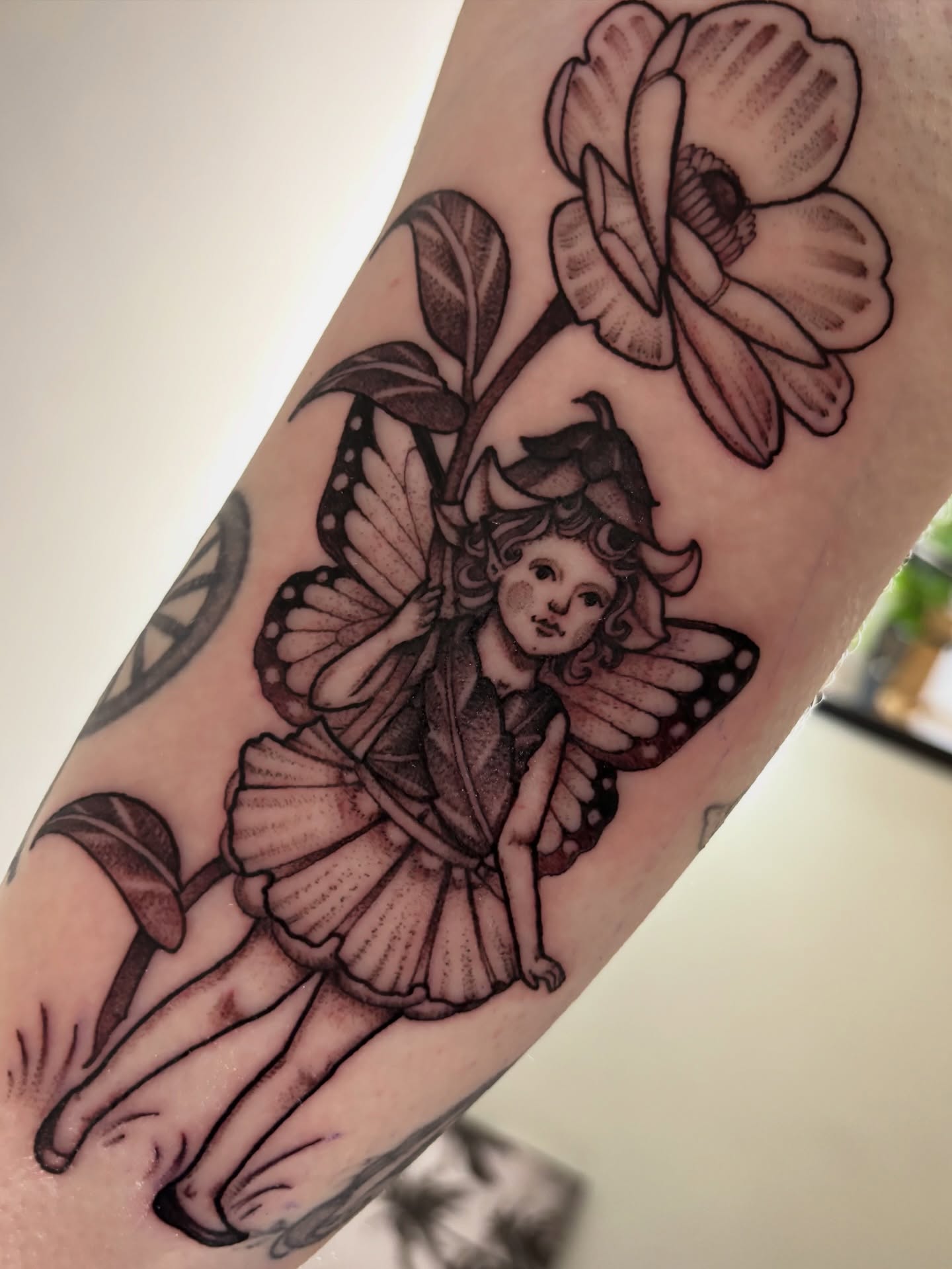 Fairy and flower black and grey tattoo on the forearm by Tara, Exeter, Pennsylvania