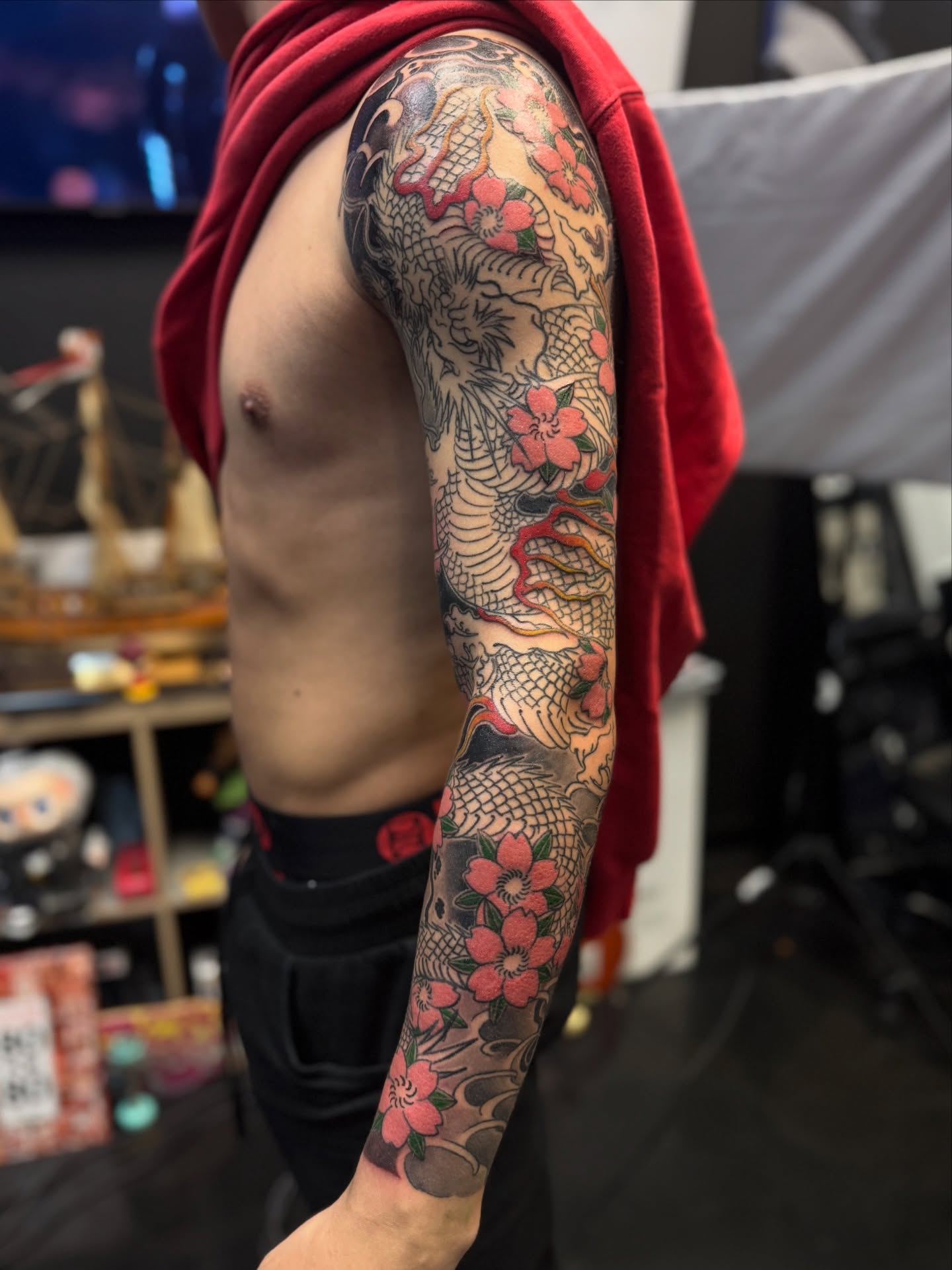 Dragon and cherry blossoms japanese irezumi tattoo on the upper arm by Zack Yang, Houston, Texas