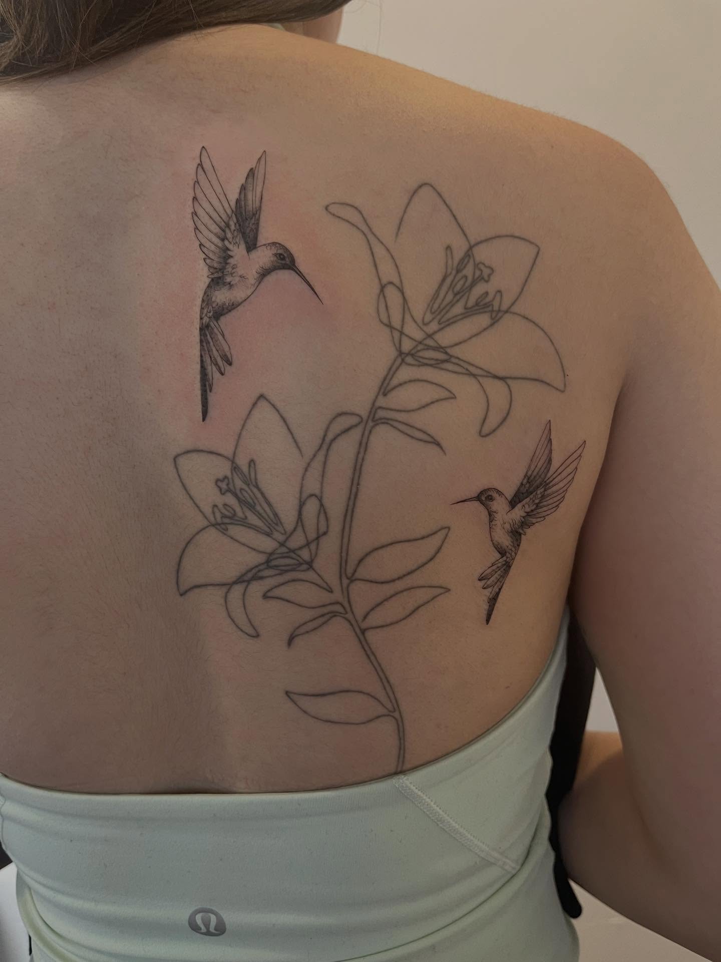 Hummingbirds and lilies realism tattoo on the back by Kite.Tattoo_Amber