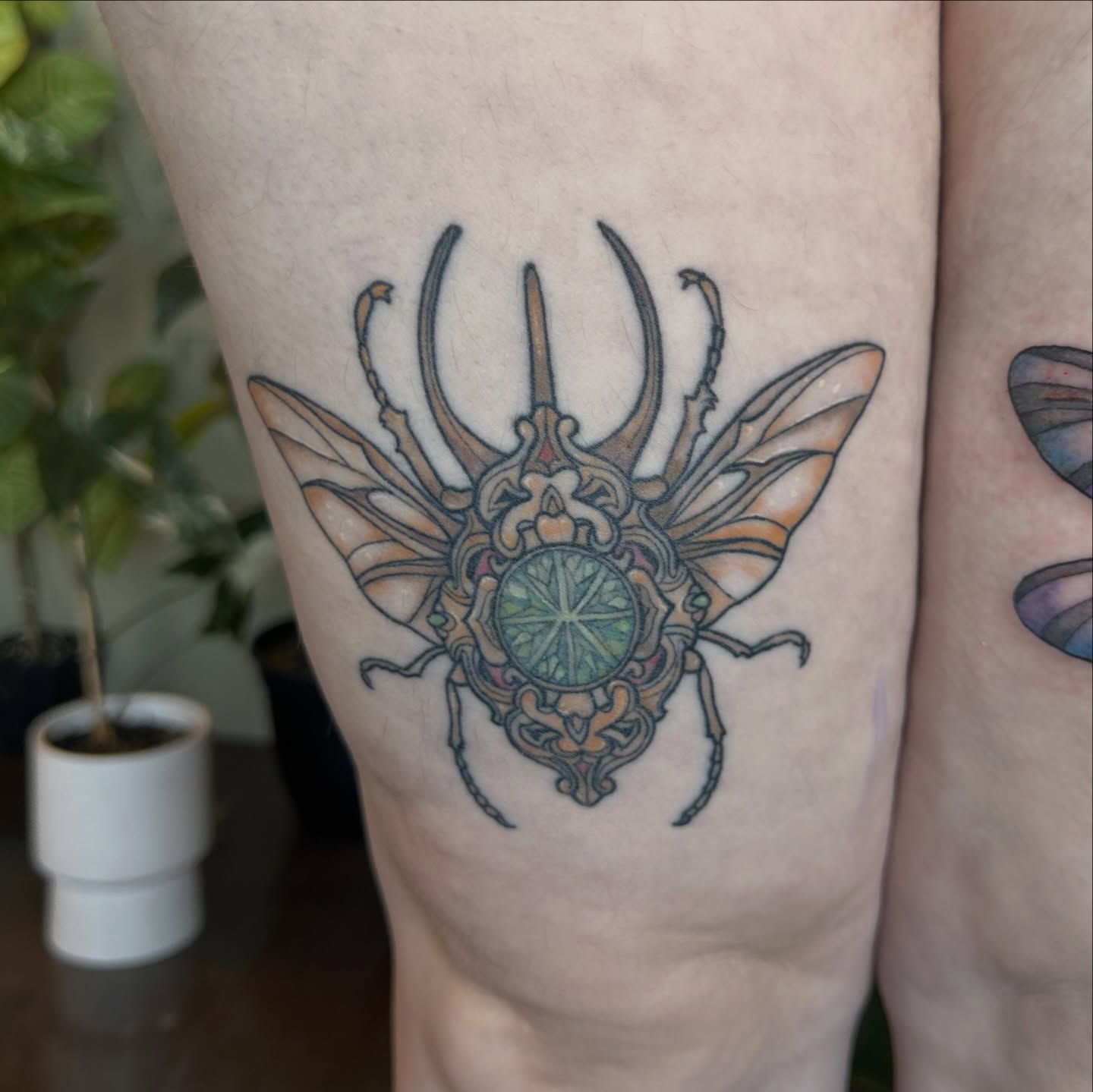 Insect geometric tattoo on the thigh by Ransom