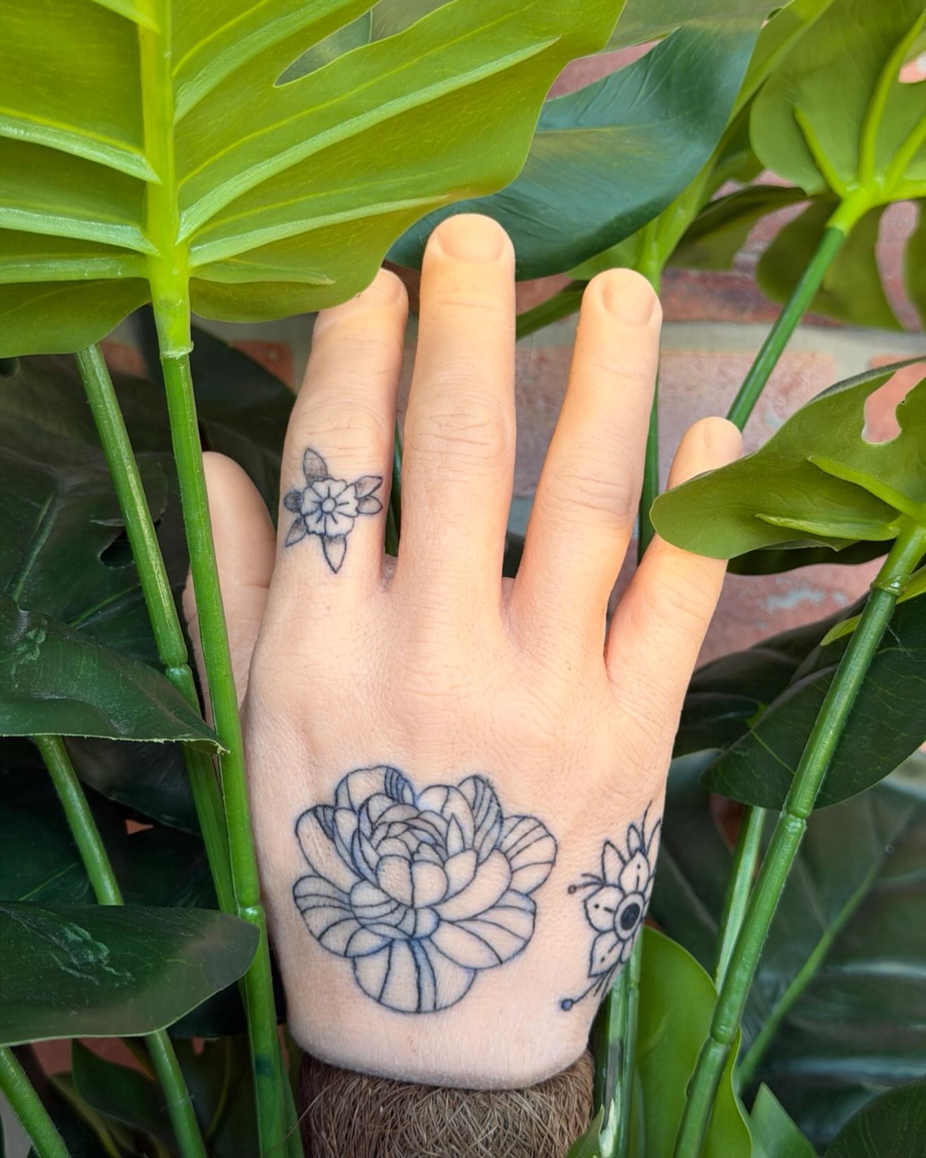 Lotus flower black and grey tattoo on the hand by K. Bel Art