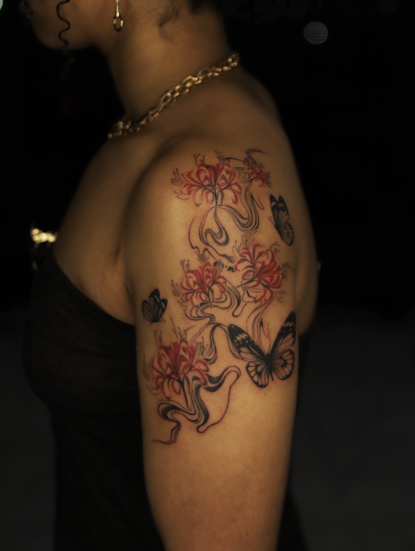 Flowers and butterflies new school tattoo on the shoulder by Las Vegas tattoo