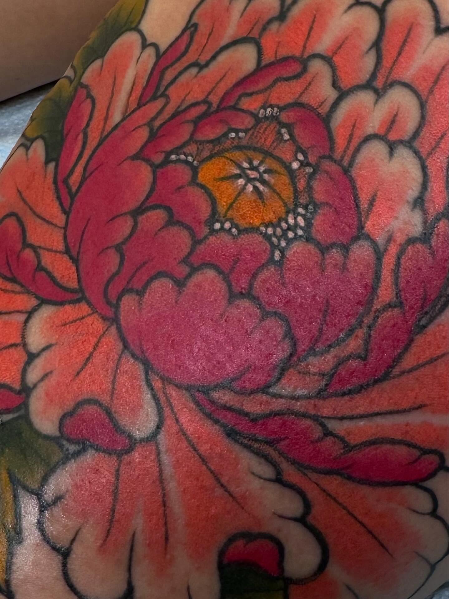 Peony flower American traditional tattoo on the upper arm by Tyler Harrington