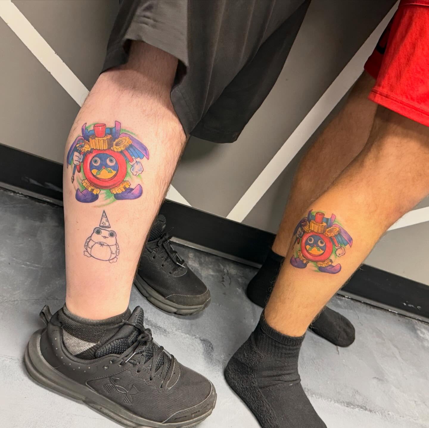 Toy-like character new school tattoo on the leg by Katie Rojas