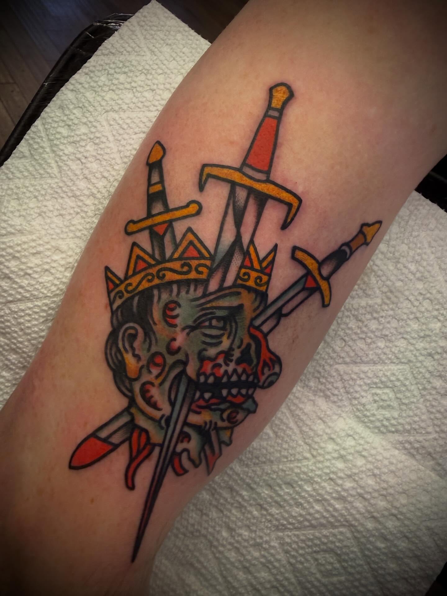 King's head with swords American traditional tattoo on the forearm by Andrew Slater