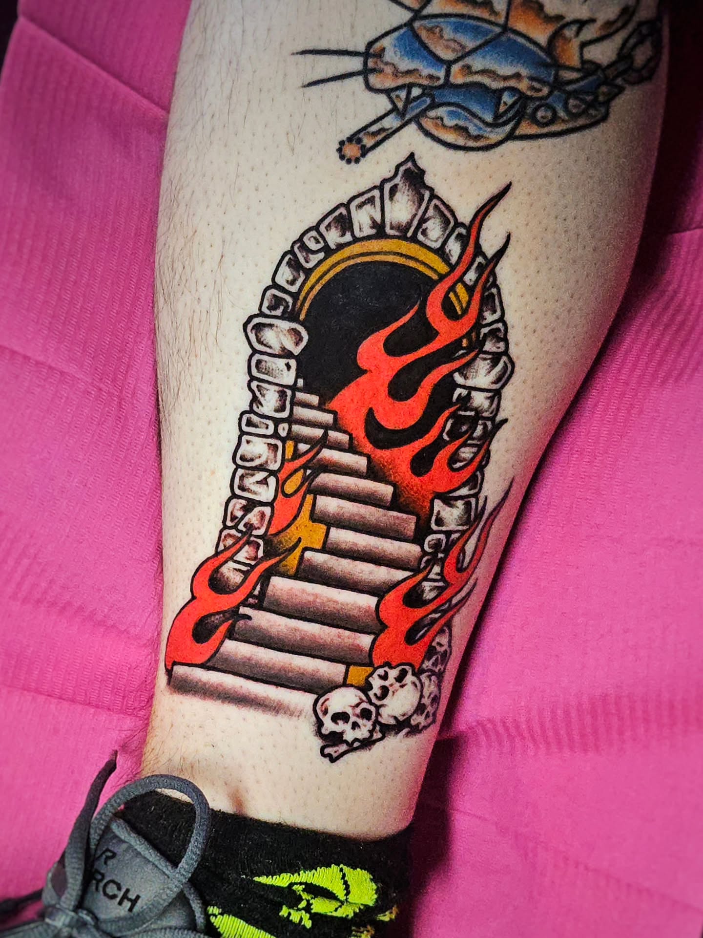 Flames and piano keys American traditional tattoo on the forearm by Monaca Patterson