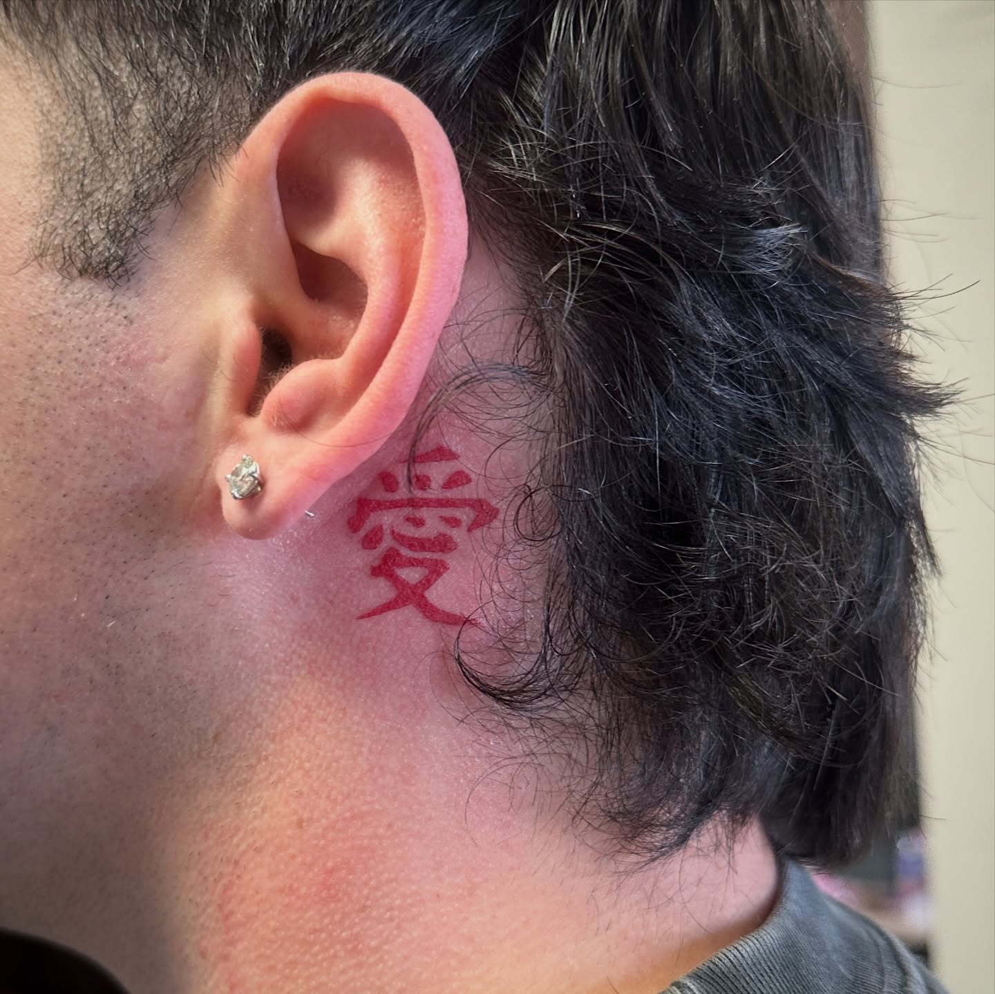 Kanji character lettering script tattoo on the neck by Luisa Gonzalez, Austin, Texas