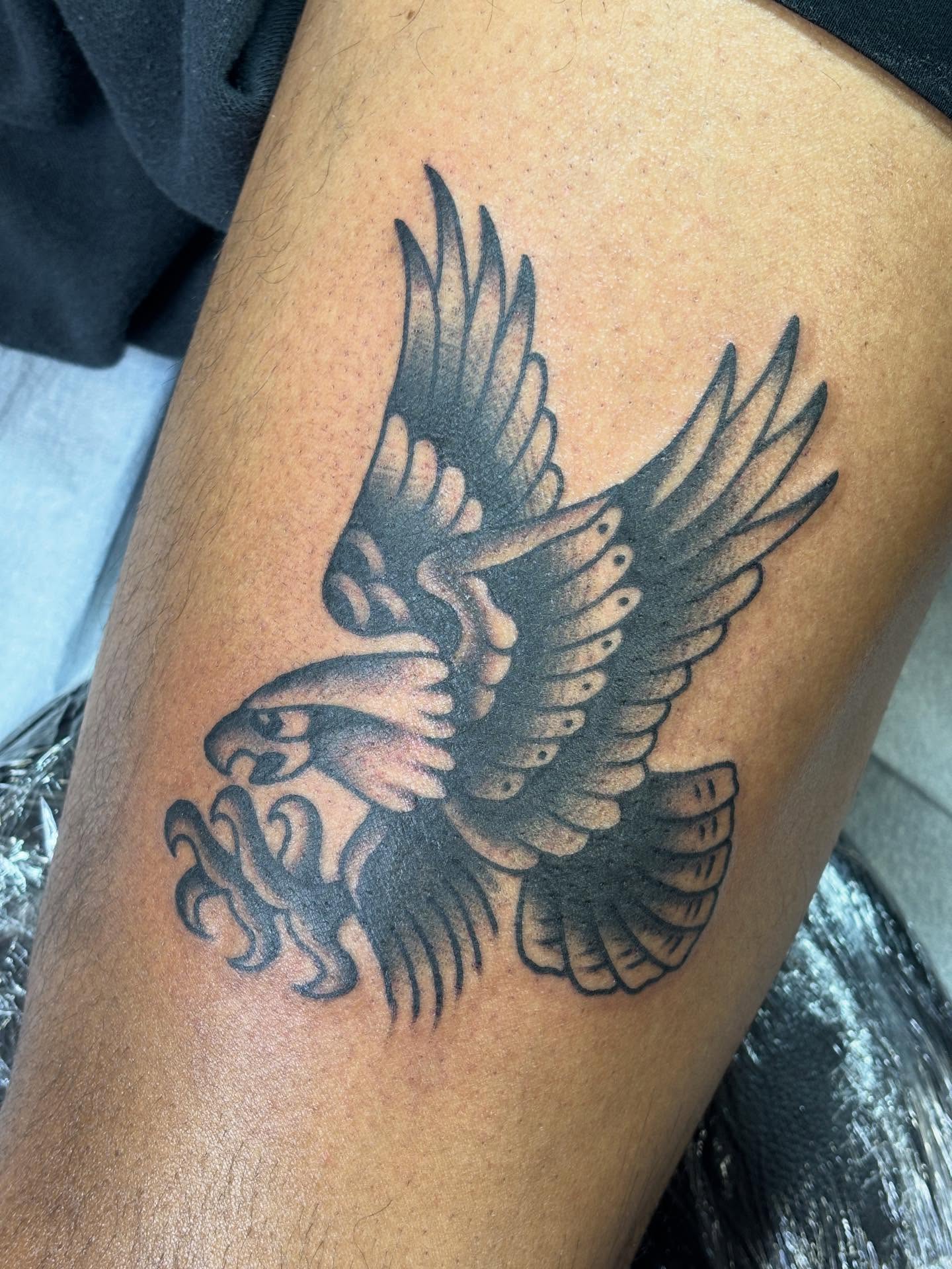 Eagle black and grey tattoo on the thigh by Mike DiCicco