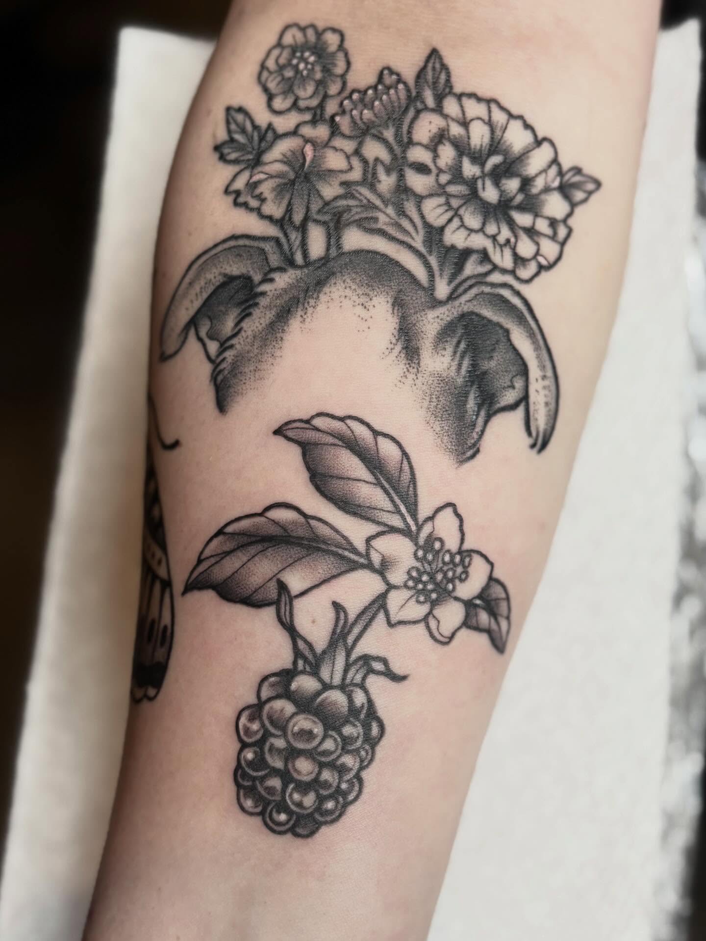 Fruit and flowers black and grey tattoo on the forearm by Mim