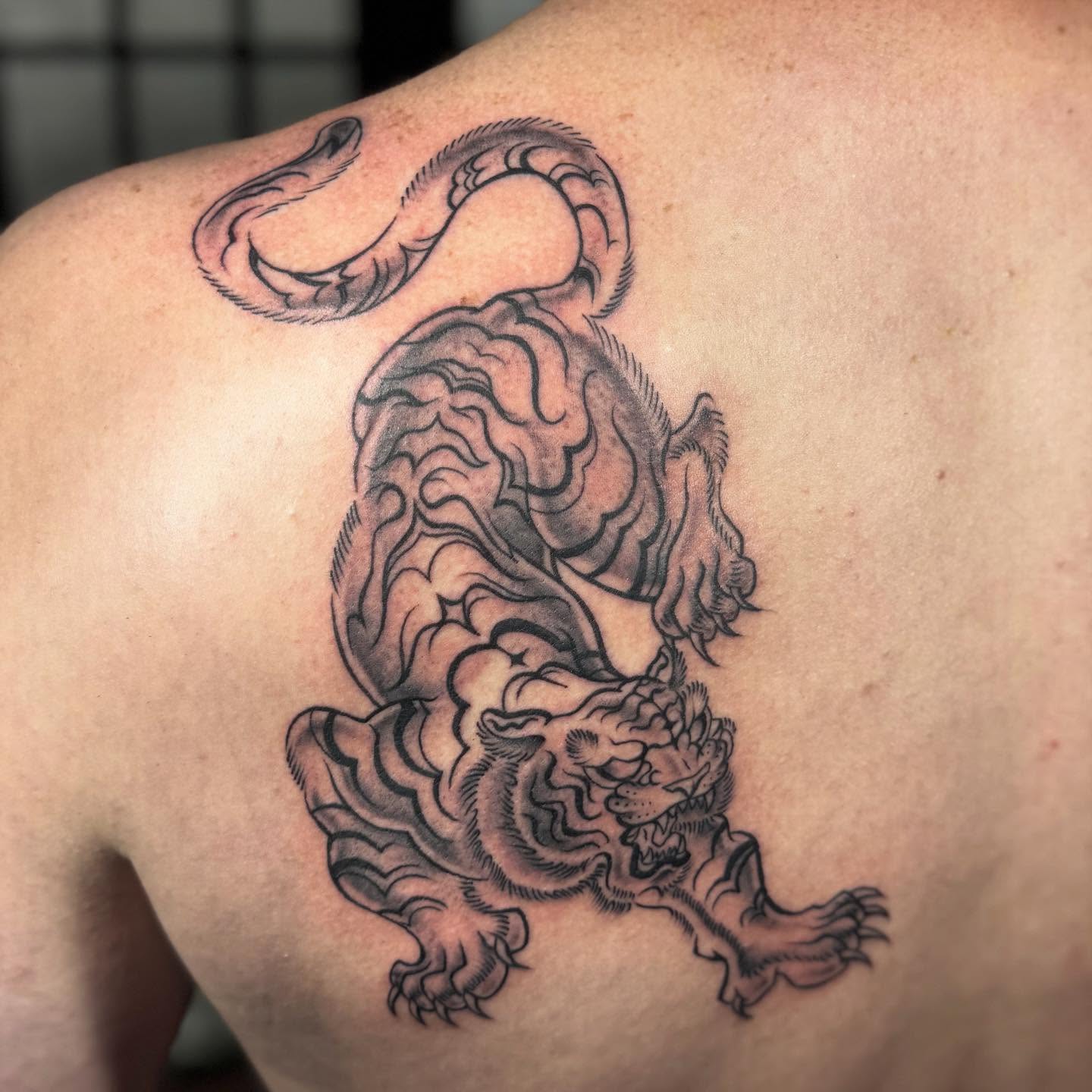 Dragon black and grey tattoo on the back by Justina🪐