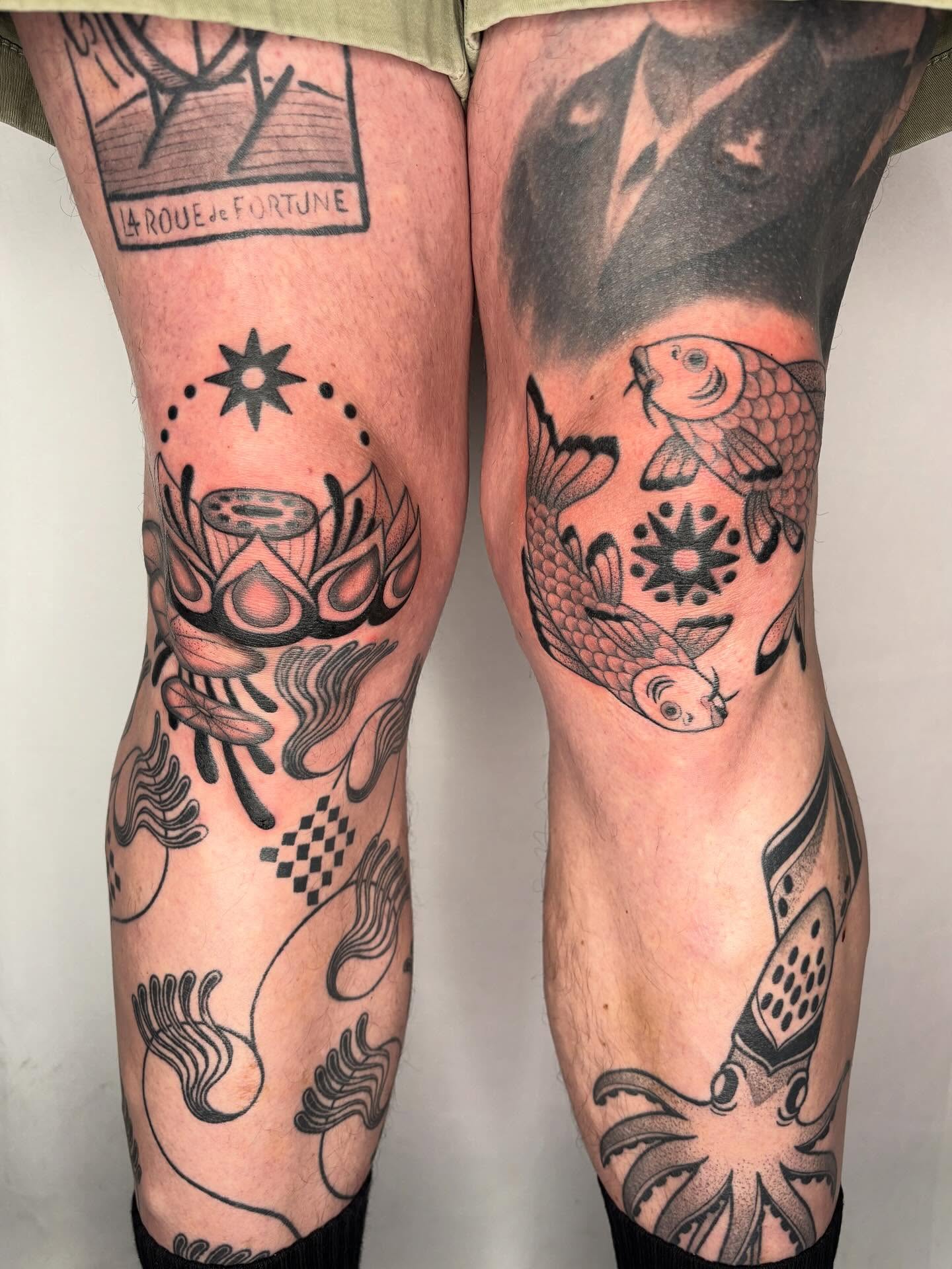 Koi fish and fortune wheel geometric tattoo on the leg by Victoria Bacon