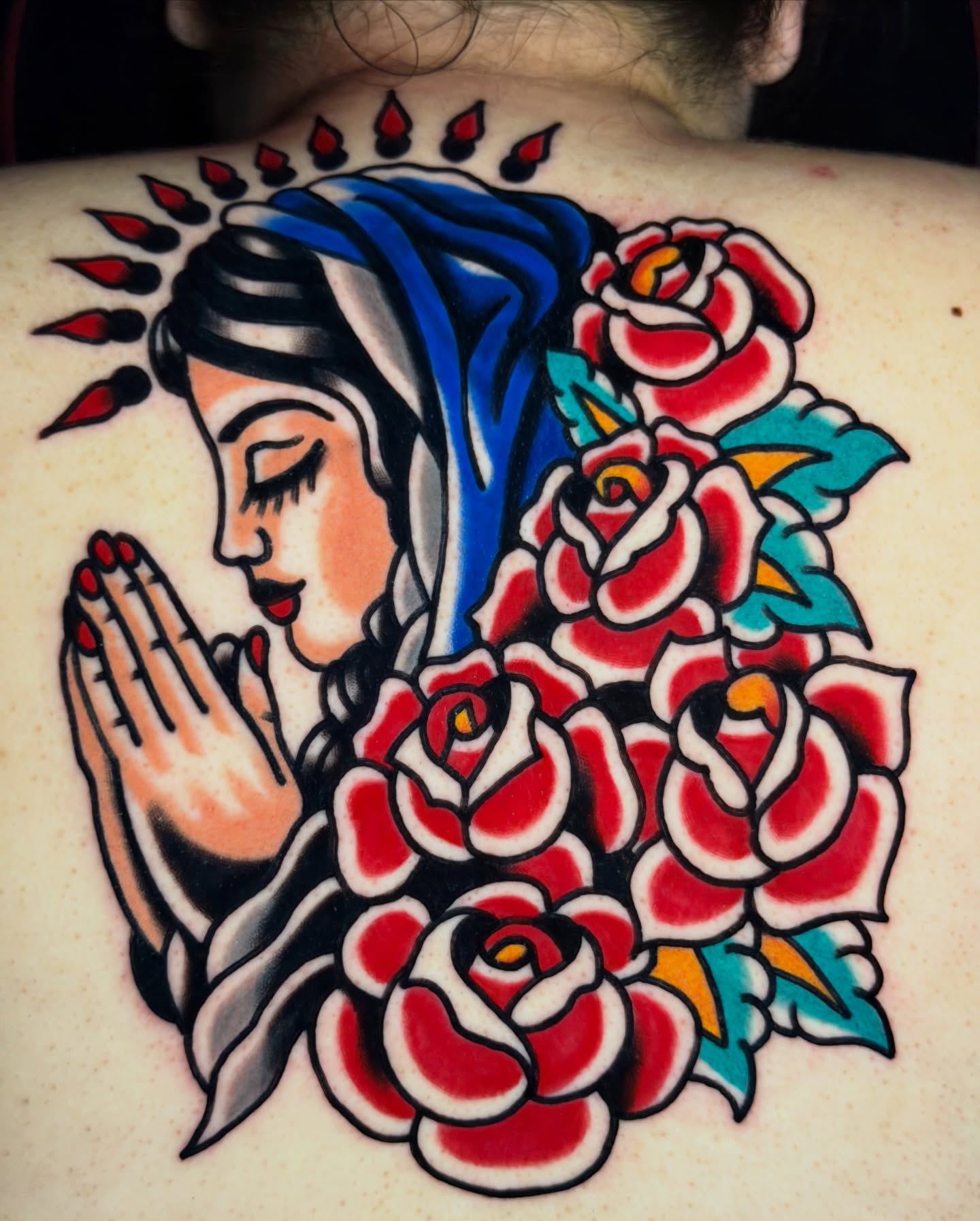 Praying woman with roses American traditional tattoo on the back by Javin Klingelhoefer Mosley