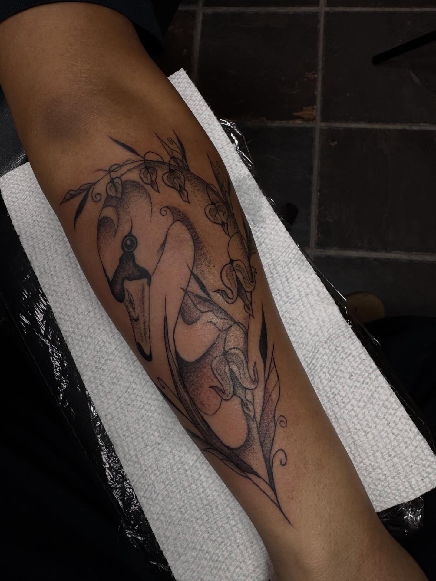 Swan and bamboo dotwork tattoo on the forearm by olivia reed