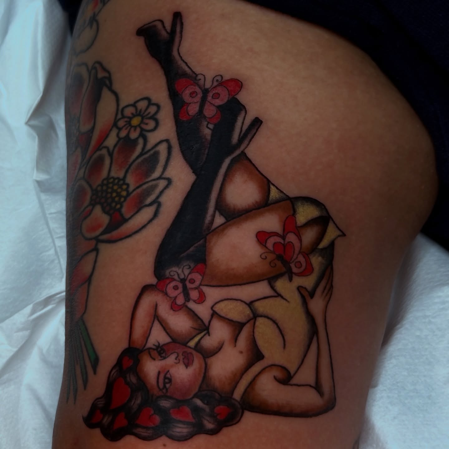 Woman with butterflies American traditional tattoo on the thigh by Kat McCoy Guidera, Nashville, Tennessee