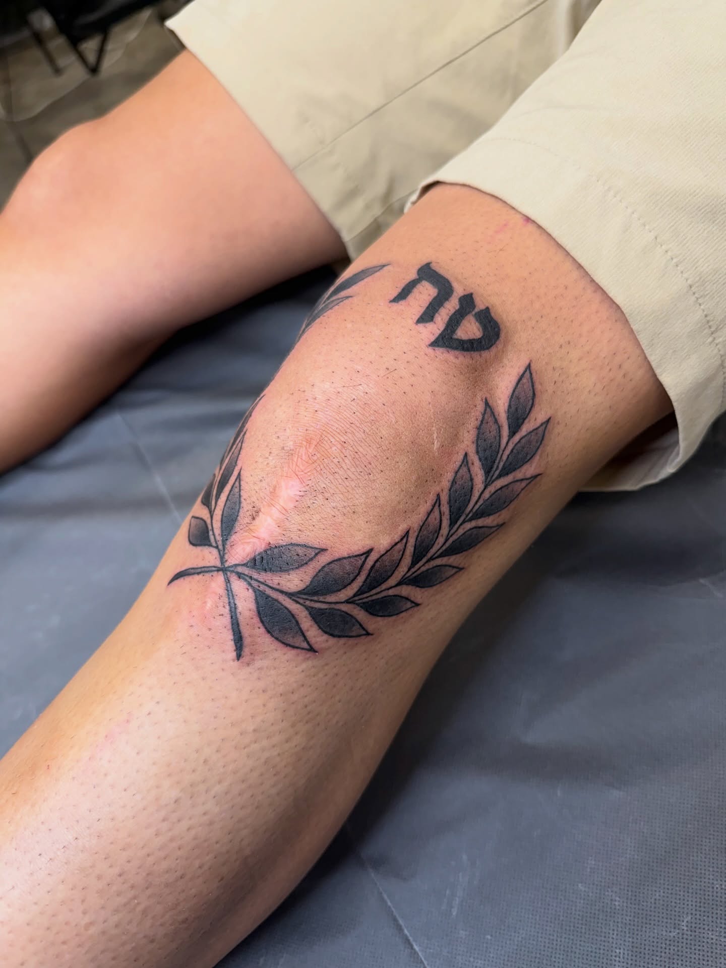Branch with Hebrew letters black and grey tattoo on the forearm by Ricky Sanchez, Duncanville, Texas