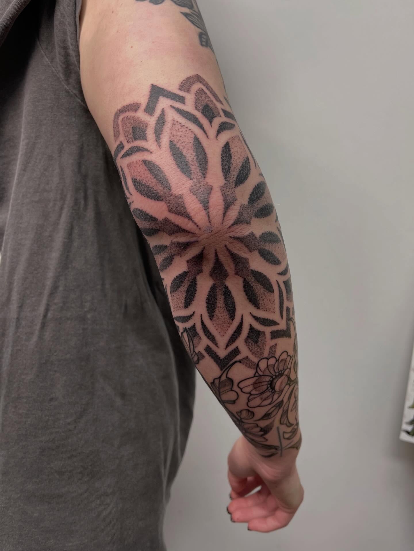 Lotus flower geometric tattoo on the forearm by Miesha Busker