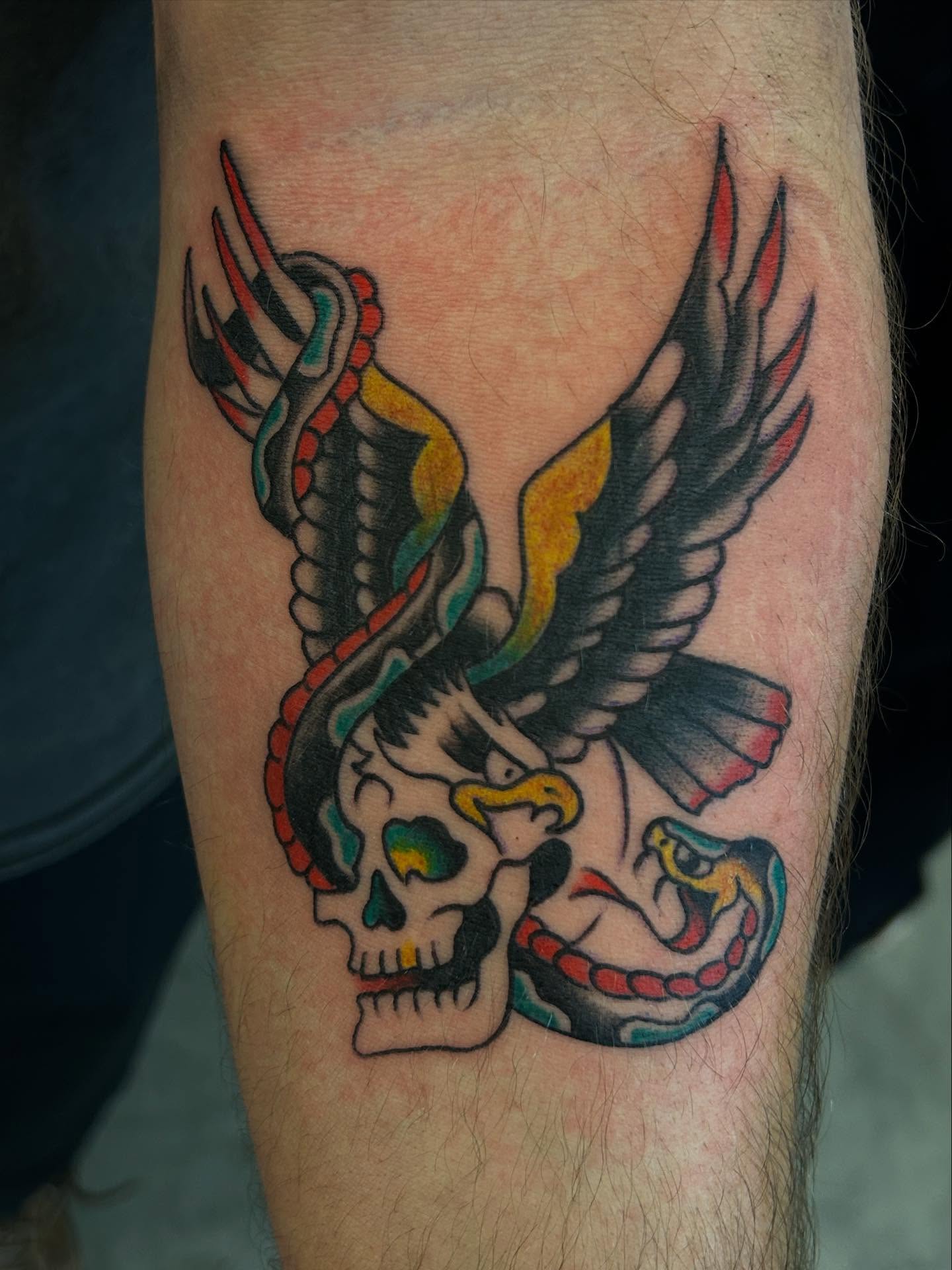 Skulls and wings American traditional tattoo on the forearm by Casey Lewis - Tattoo Artist, Cleveland Ohio