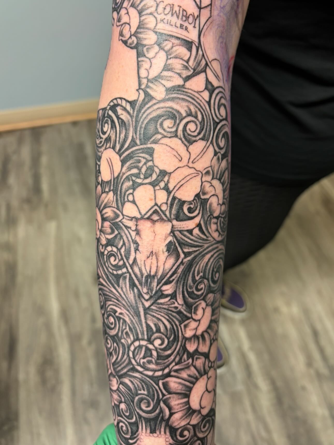 Deer skull and floral ornamental tattoo on the forearm by Jesus Pubert Munster