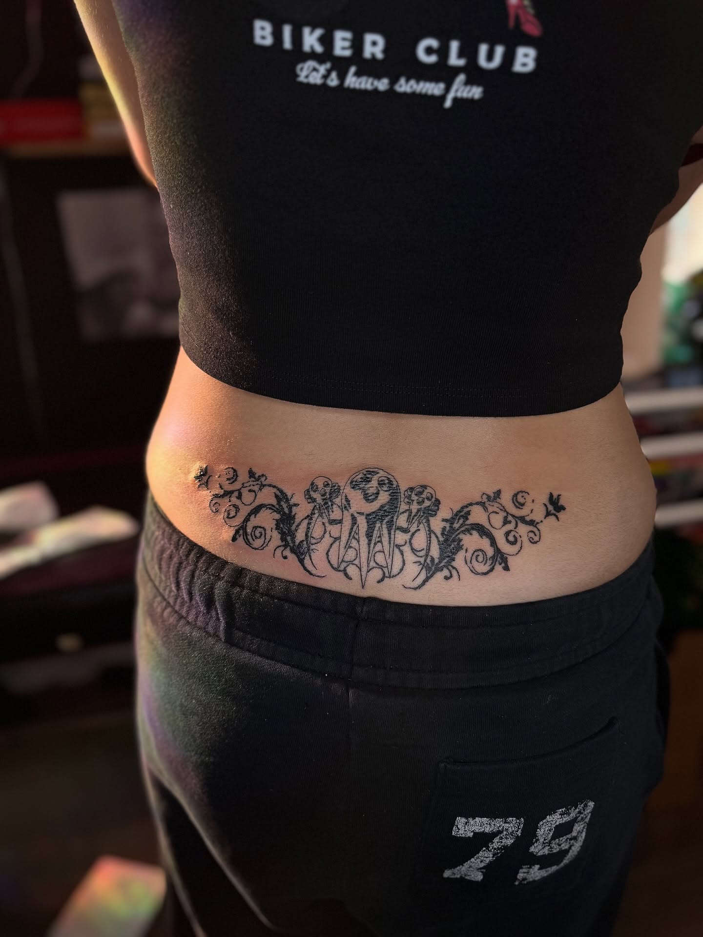 Scrollwork black and grey tattoo on the torso by Honey