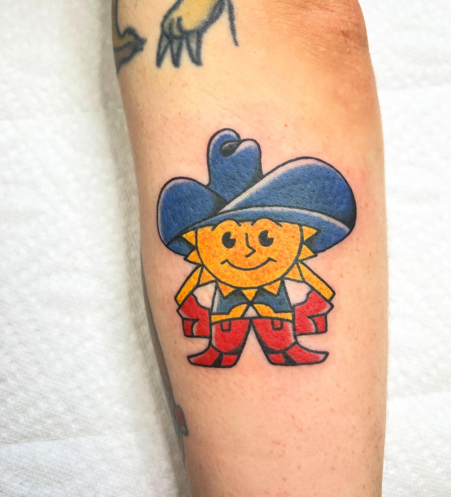 Sun character new school tattoo on the forearm by Taylor Estrella