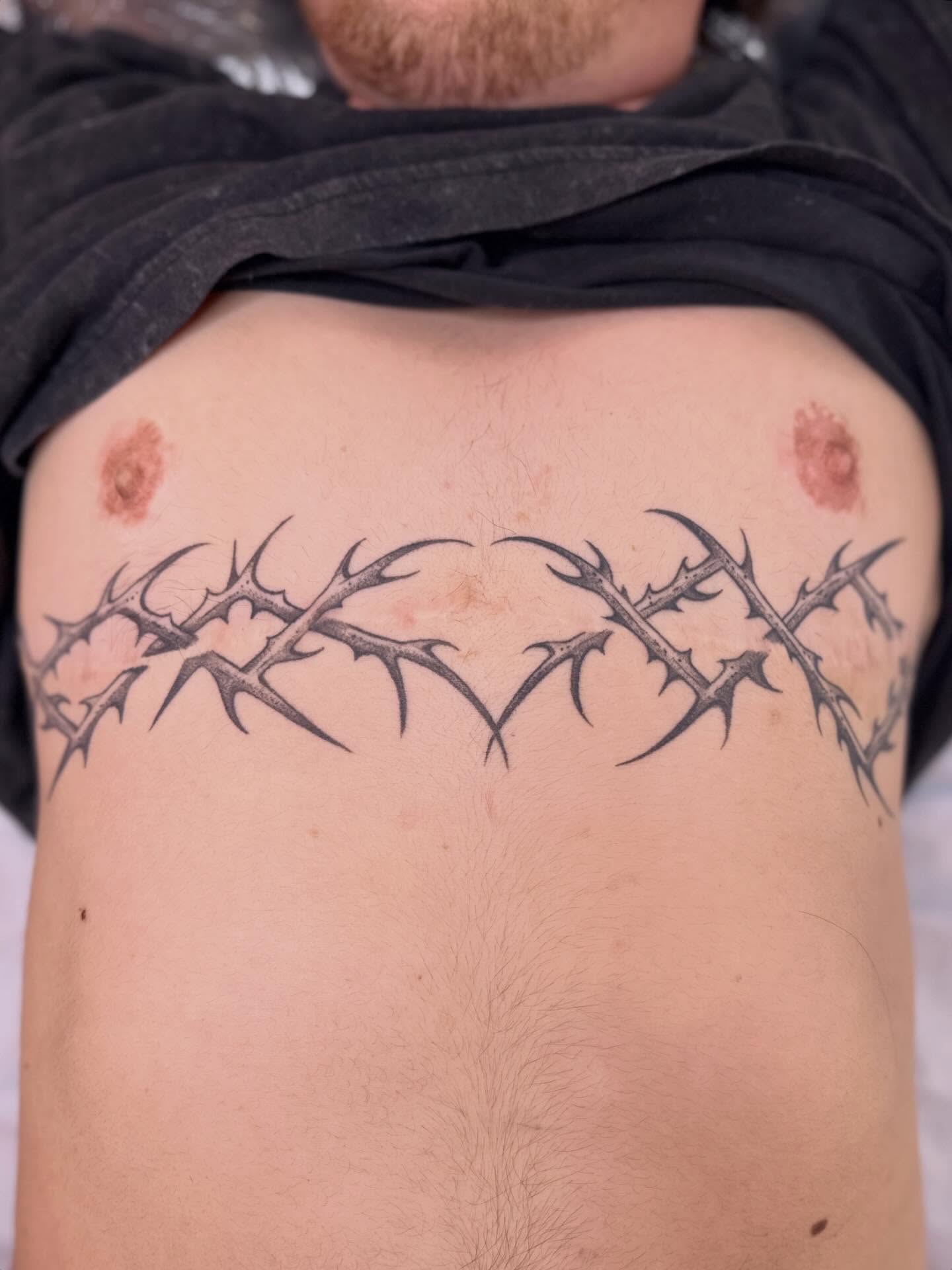 Thorns black and grey tattoo on the ribs by Dani Di Pietrantonio