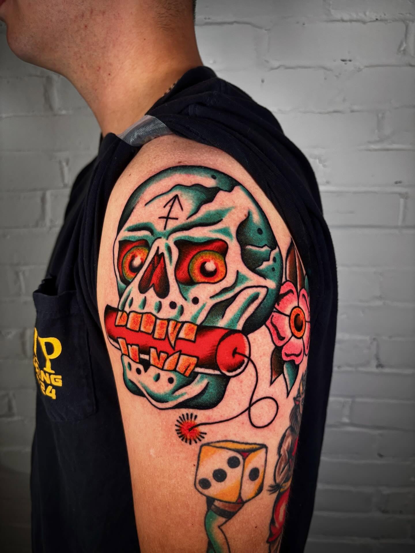 Skull with dice American traditional tattoo on the shoulder by Doug von