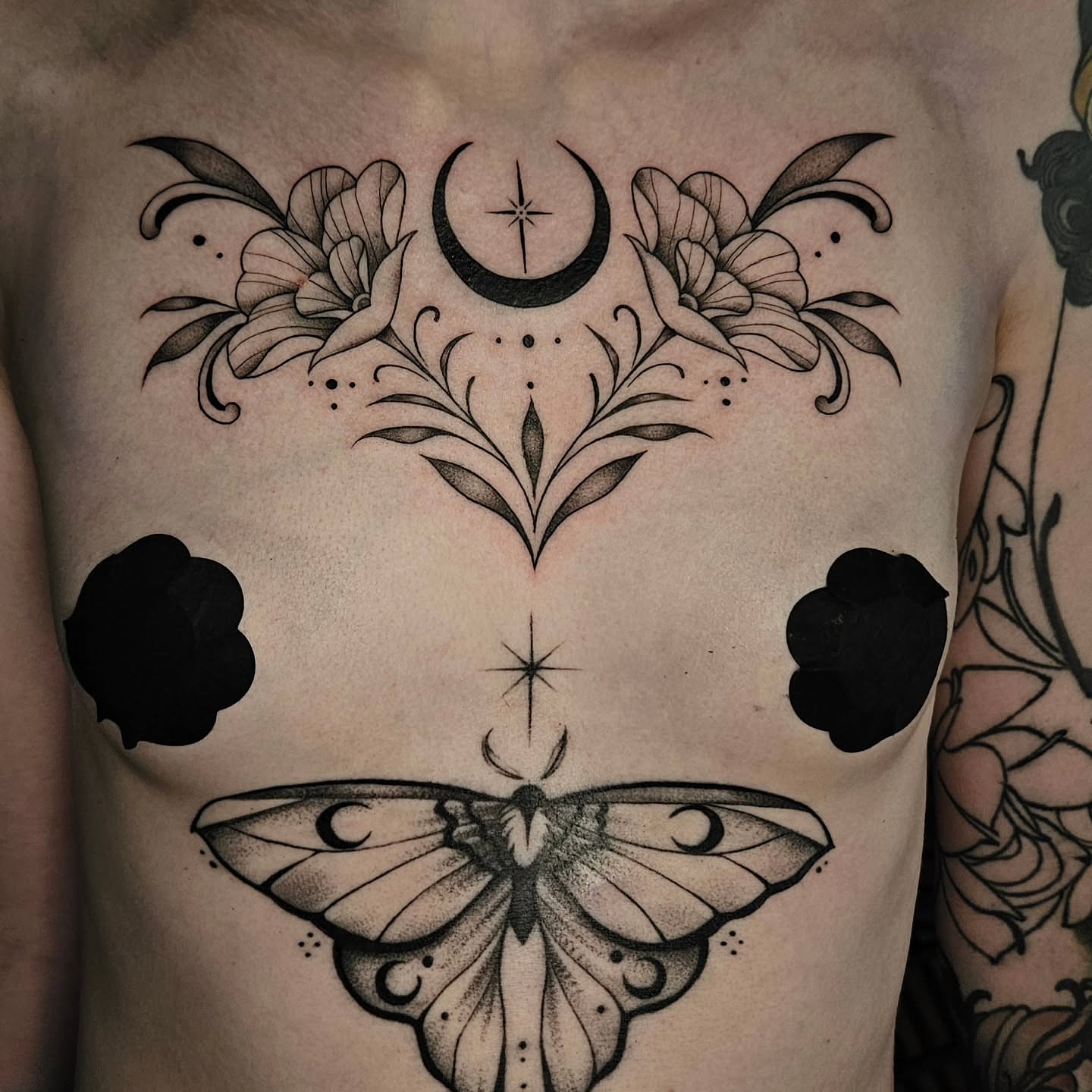 Moth and celestial symbols dotwork tattoo on the chest by Courtlyn Bliss