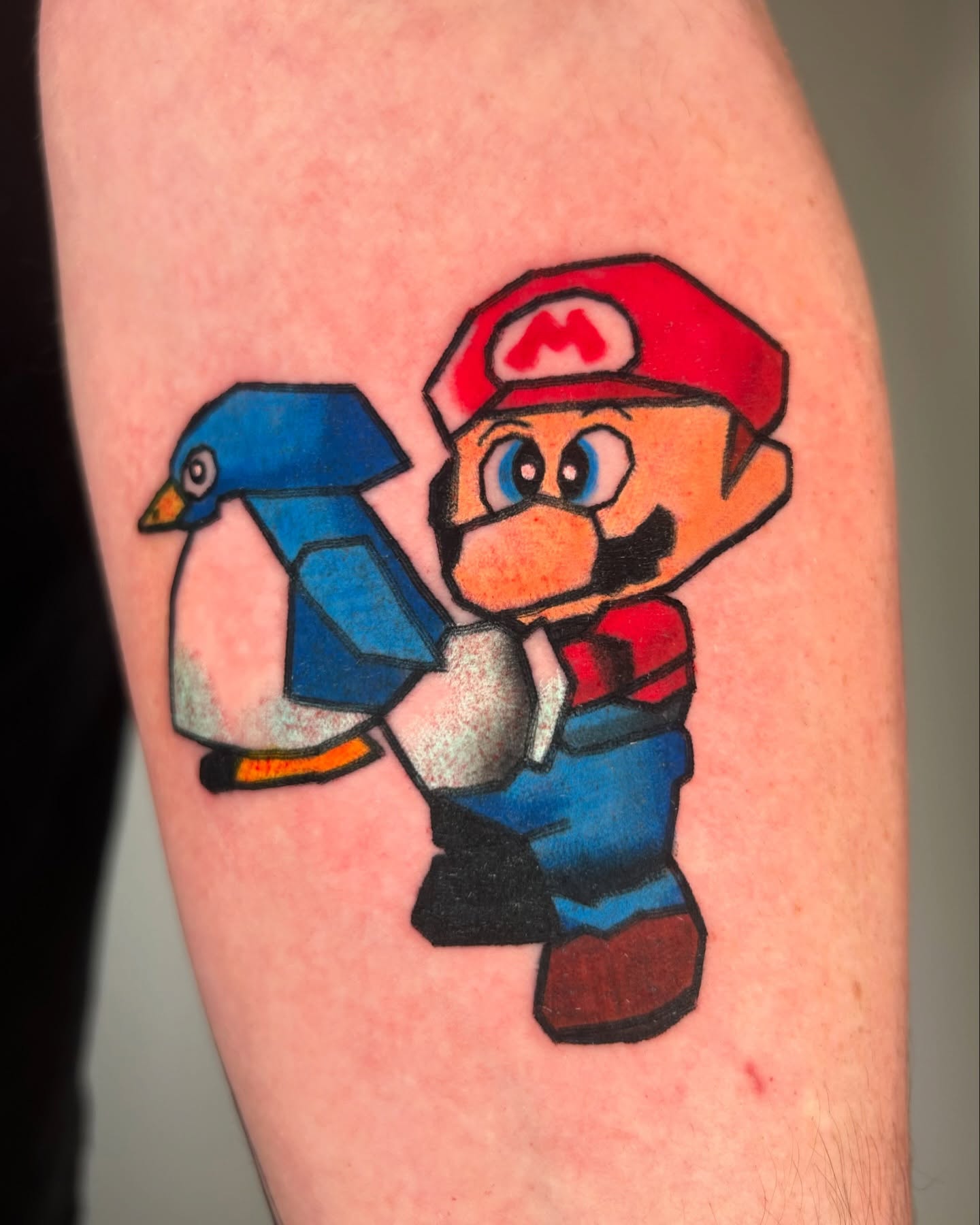 Mario holding bird geometric tattoo on the forearm by Ollie
