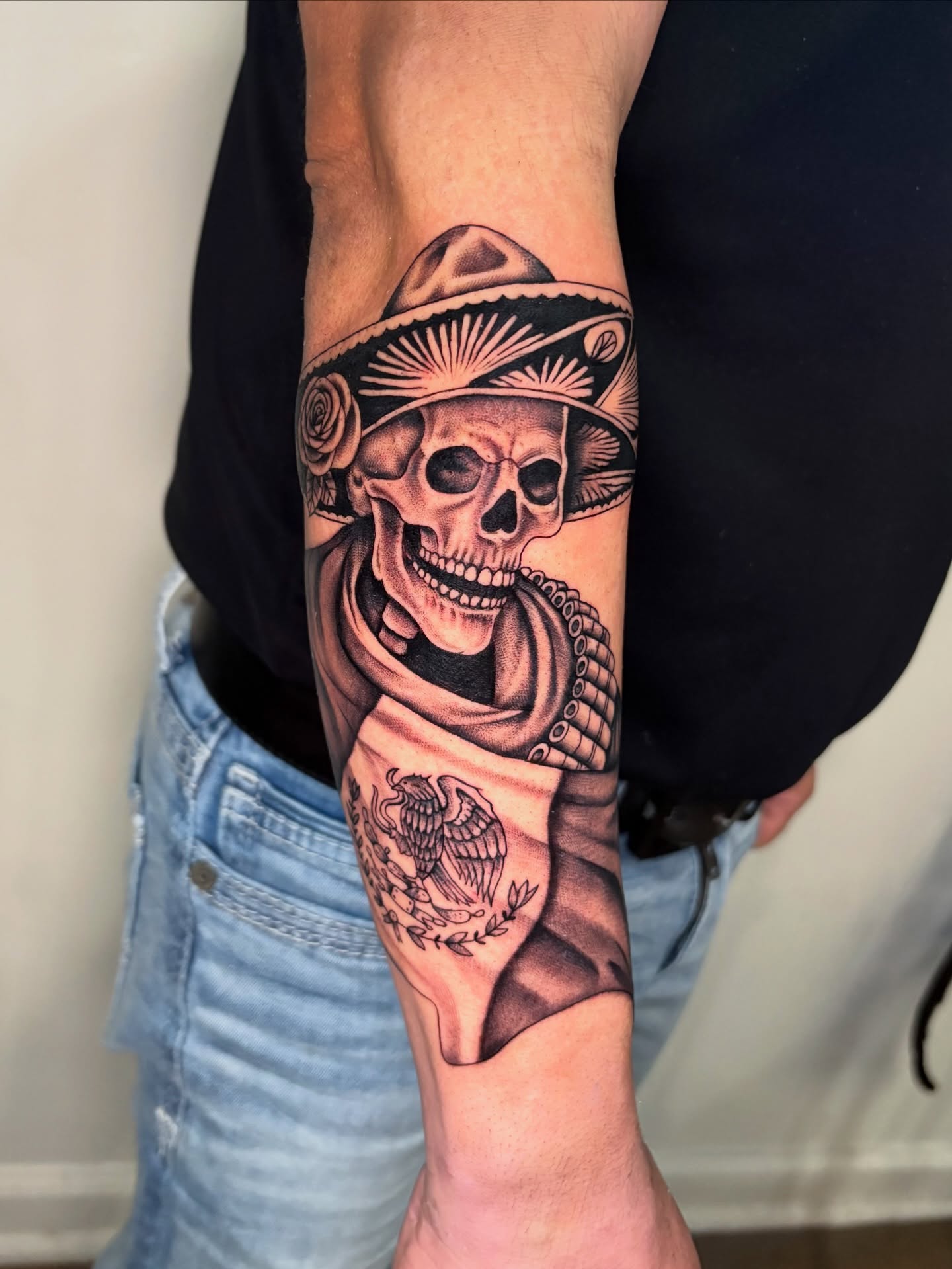 Skull wearing sombrero Chicano tattoo on the forearm by Osiel Rodriguez
