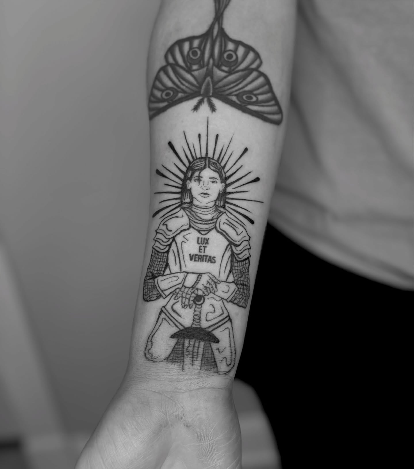 Religious figure black and grey tattoo on the forearm by Sarah