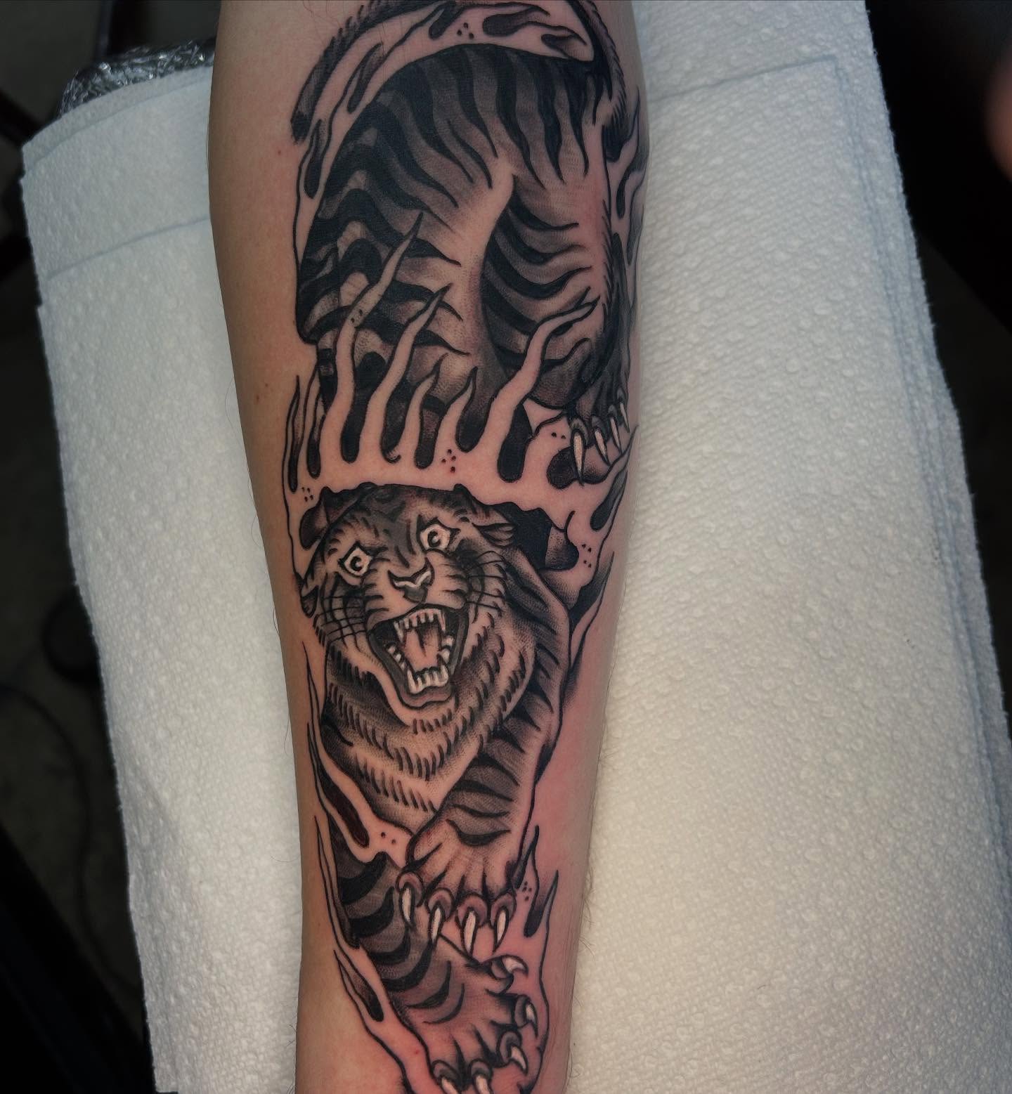 Roaring tiger black and grey tattoo on the forearm by Dylan O'Quin