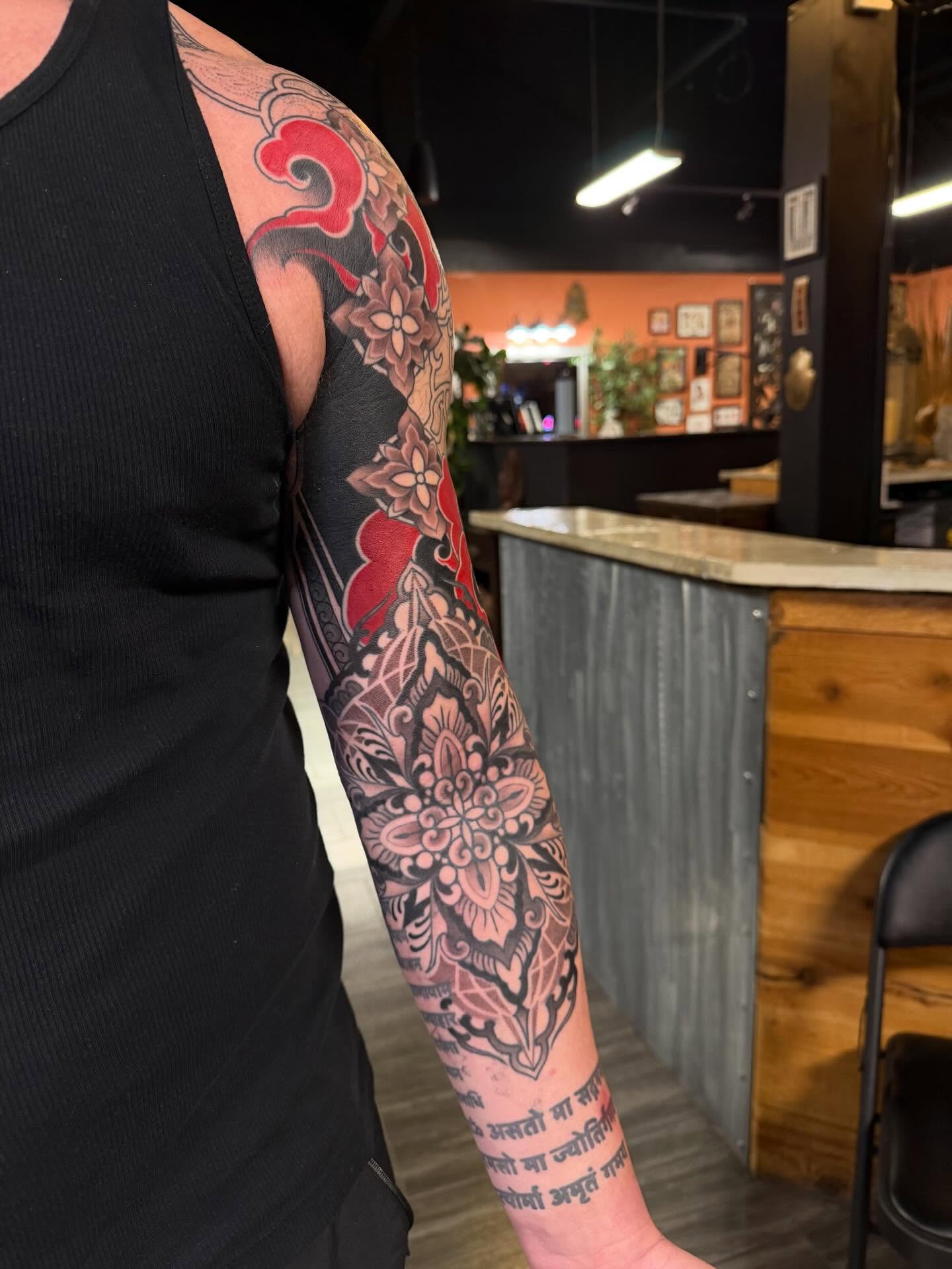Floral mandala ornamental tattoo on the upper arm by <