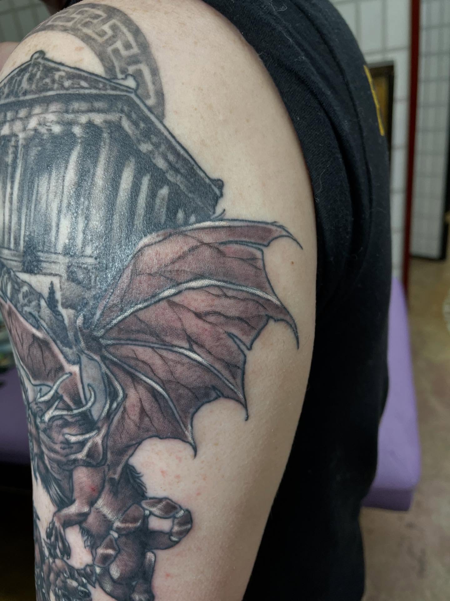 Dragon and gargoyle realism tattoo on the shoulder by Heather Freitag