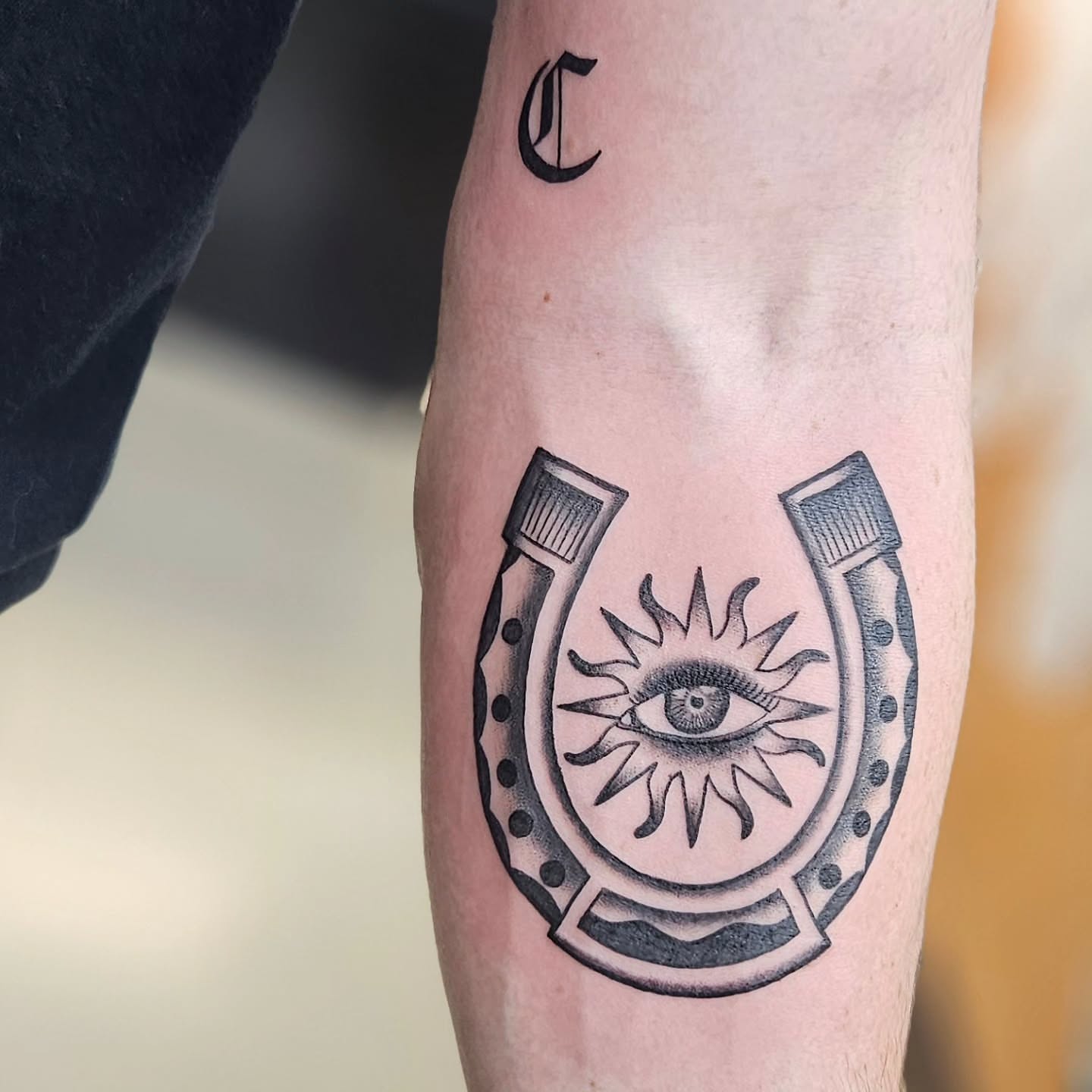 Horseshoe with eye dotwork tattoo on the forearm by Jordanna Pearl