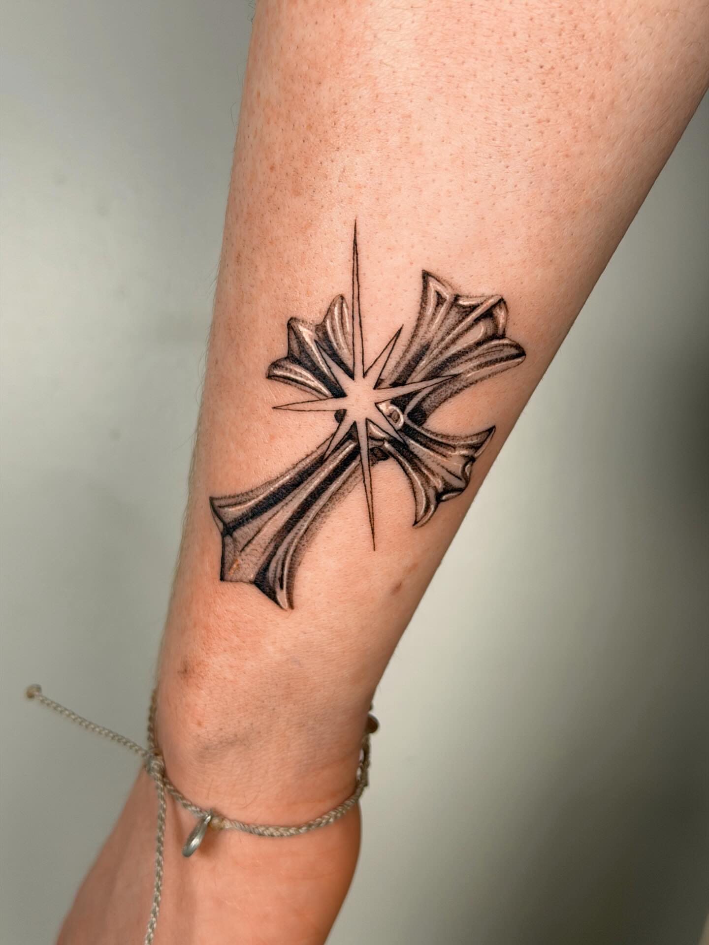 Cross black and grey tattoo on the forearm by Nate Weaver