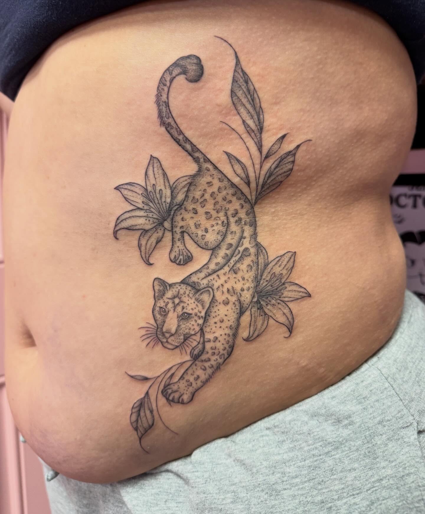 Leopard and flowers black and grey tattoo on the thigh by Jennylee Aerts, Asbury Park, New Jersey
