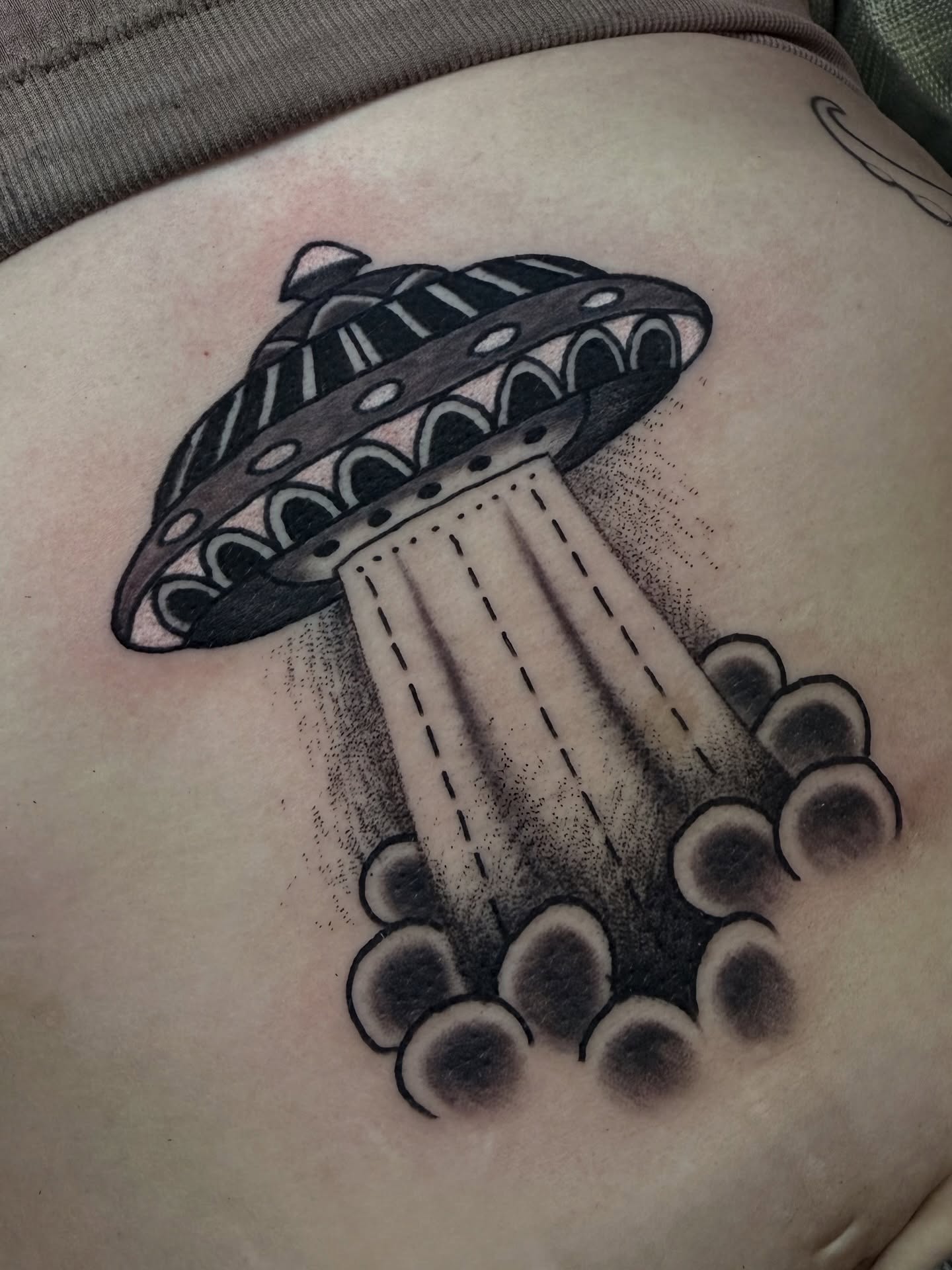 UFO abduction black and grey tattoo on the thigh by Jhon