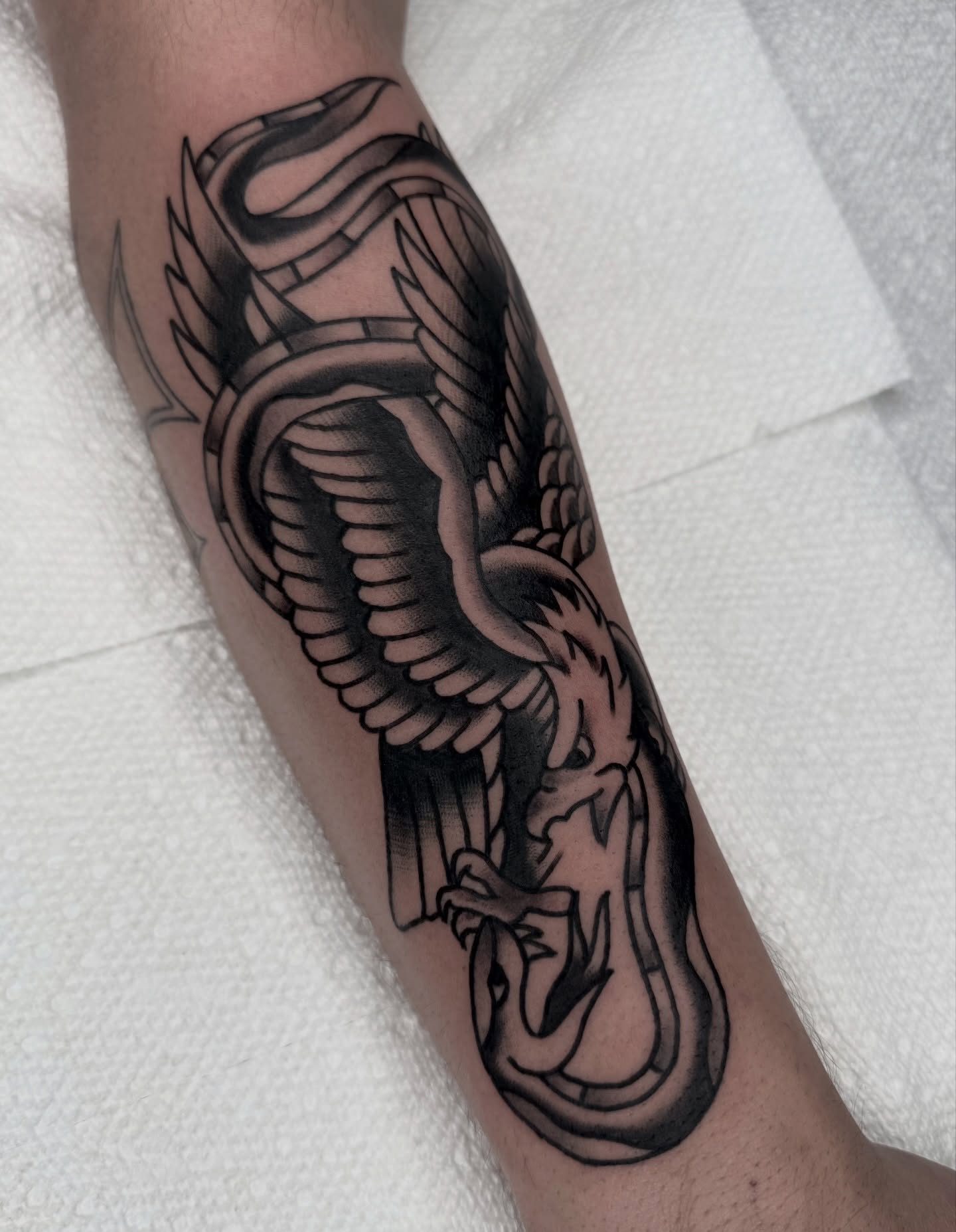 Winged dragon geometric tattoo on the forearm by Drew🕸️, Phoenix, Arizona
