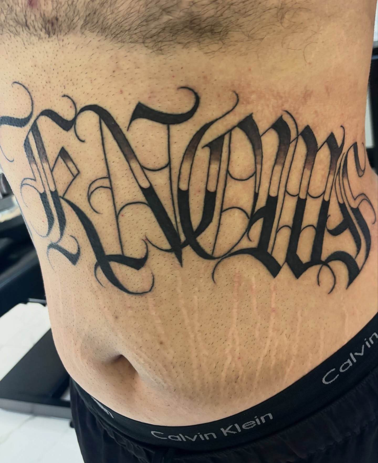 Script lettering lettering script tattoo on the torso by Cristiano Ochoa, Elk Grove, California