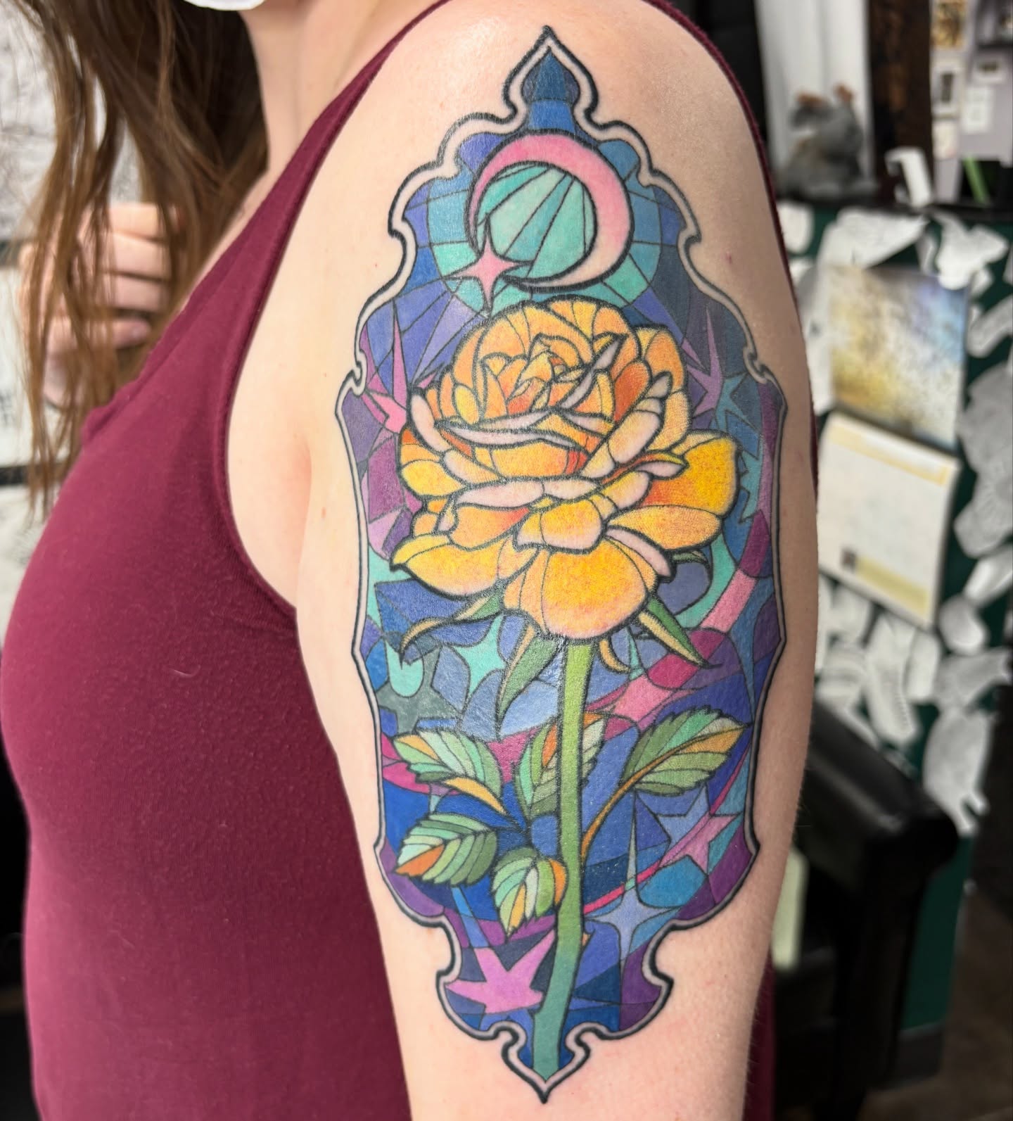 Stained glass rose geometric tattoo on the upper arm by Lu Taylor, Minneapolis, Minnesota