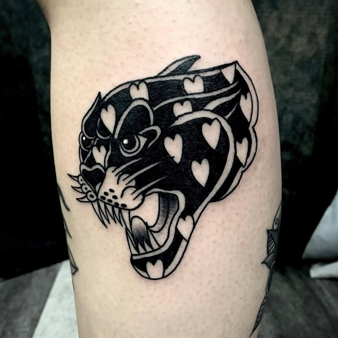 Panther black and grey tattoo on the forearm by Sean Gallagher
