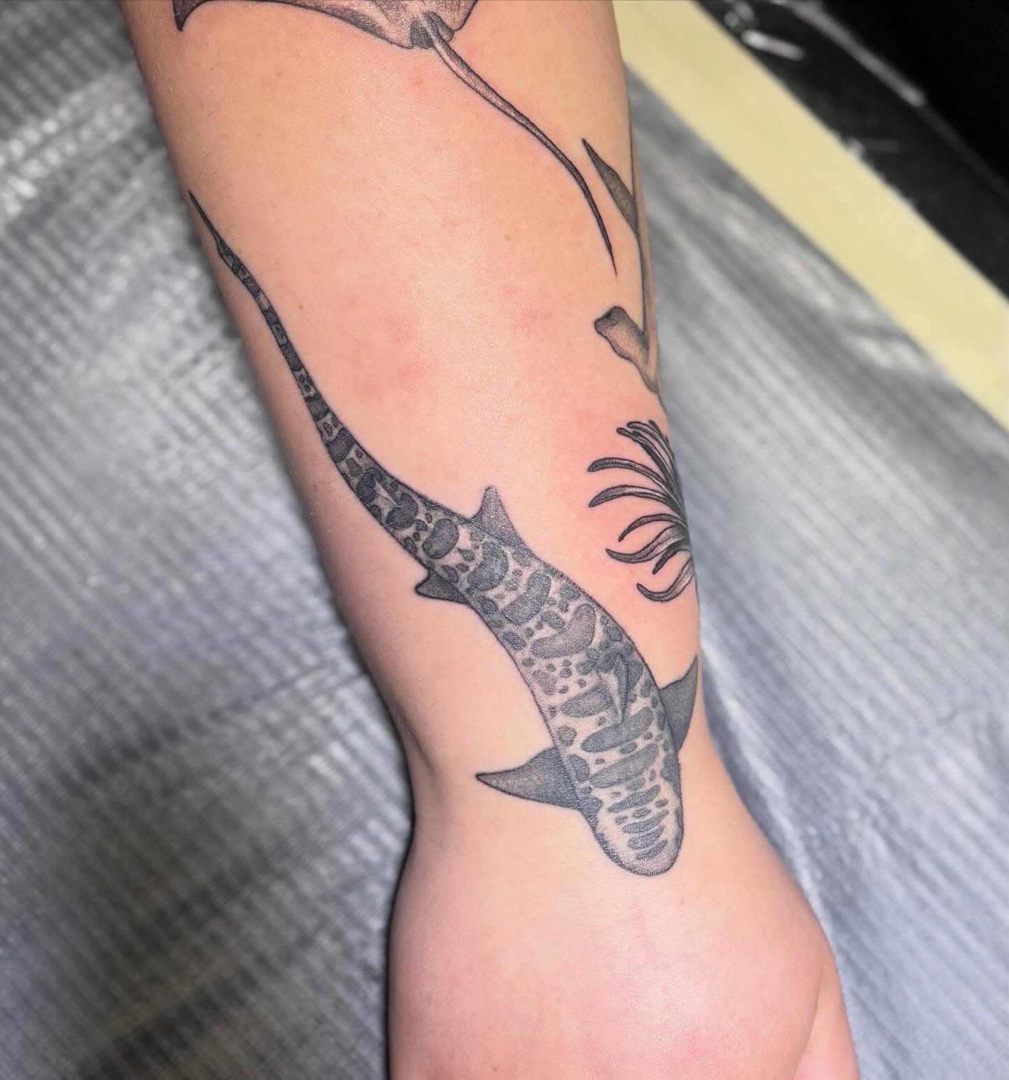 Shark black and grey tattoo on the forearm by Olivia Buch