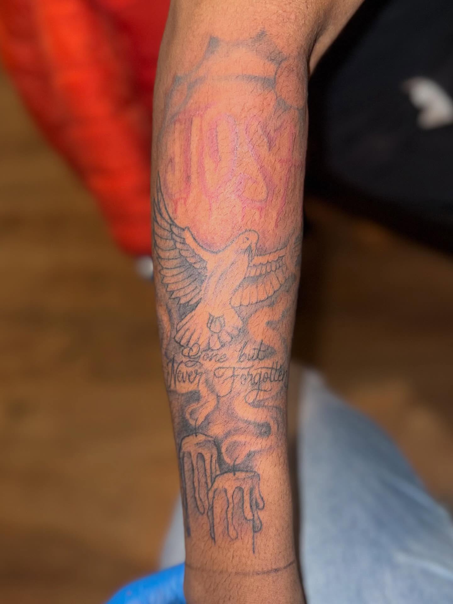 Bird and candles black and grey tattoo on the forearm by Aja Marie