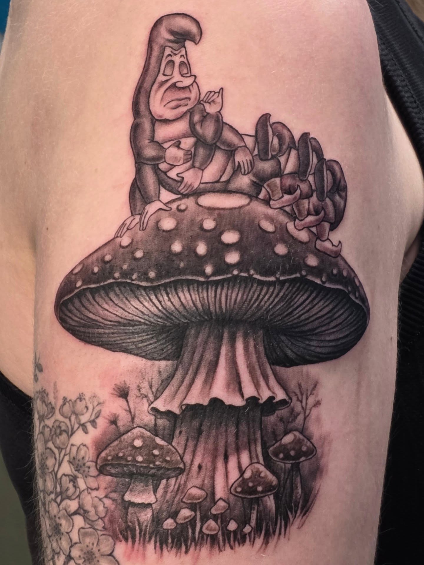 Gnome on mushroom black and grey tattoo on the forearm by Martin Colonna