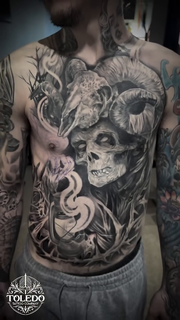 Skull and ram with smoke realism tattoo on the torso by Kodi Klo