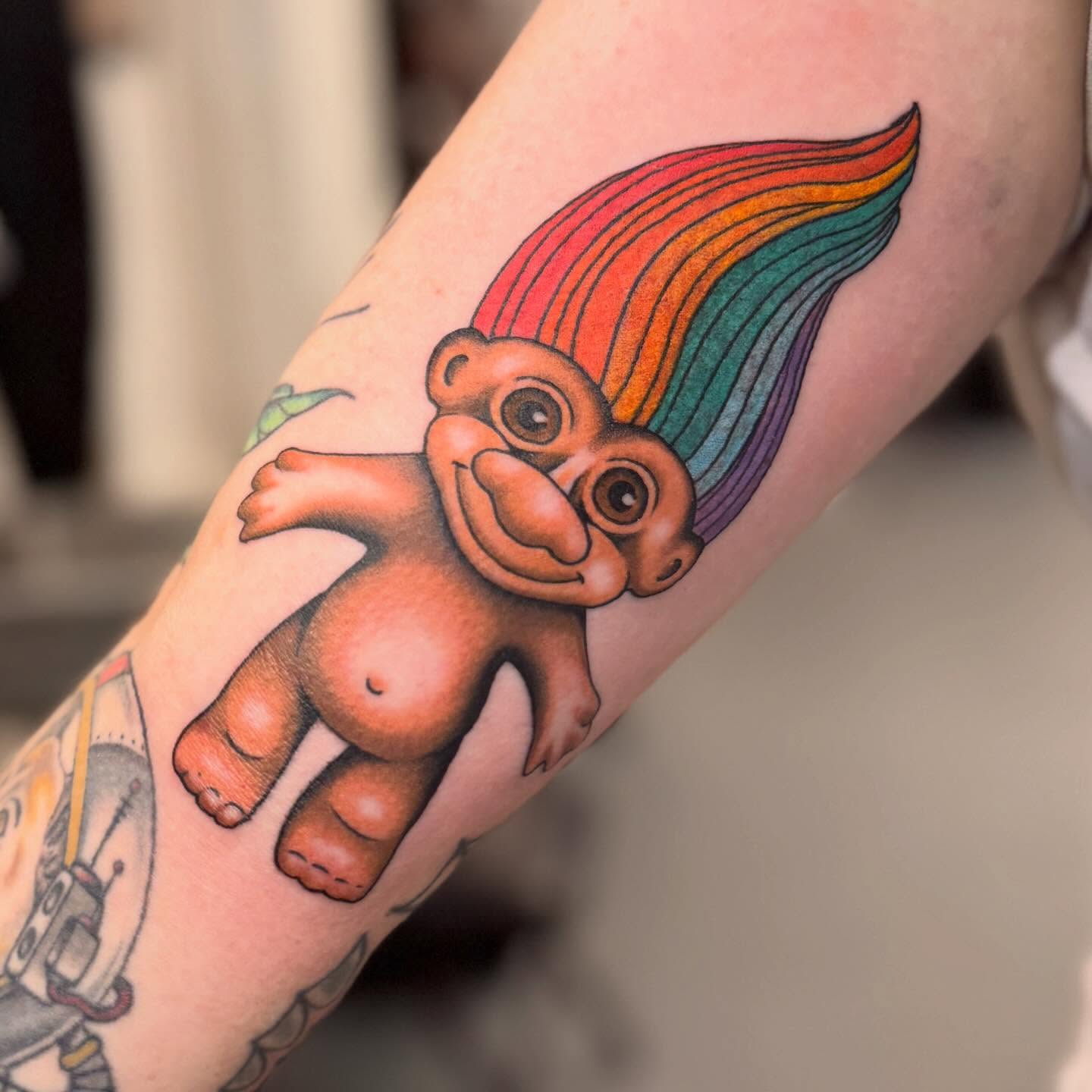 Troll with rainbow hair realism tattoo on the forearm by Cole Pittman Memphis Tattoo artist, Memphis, Tennessee