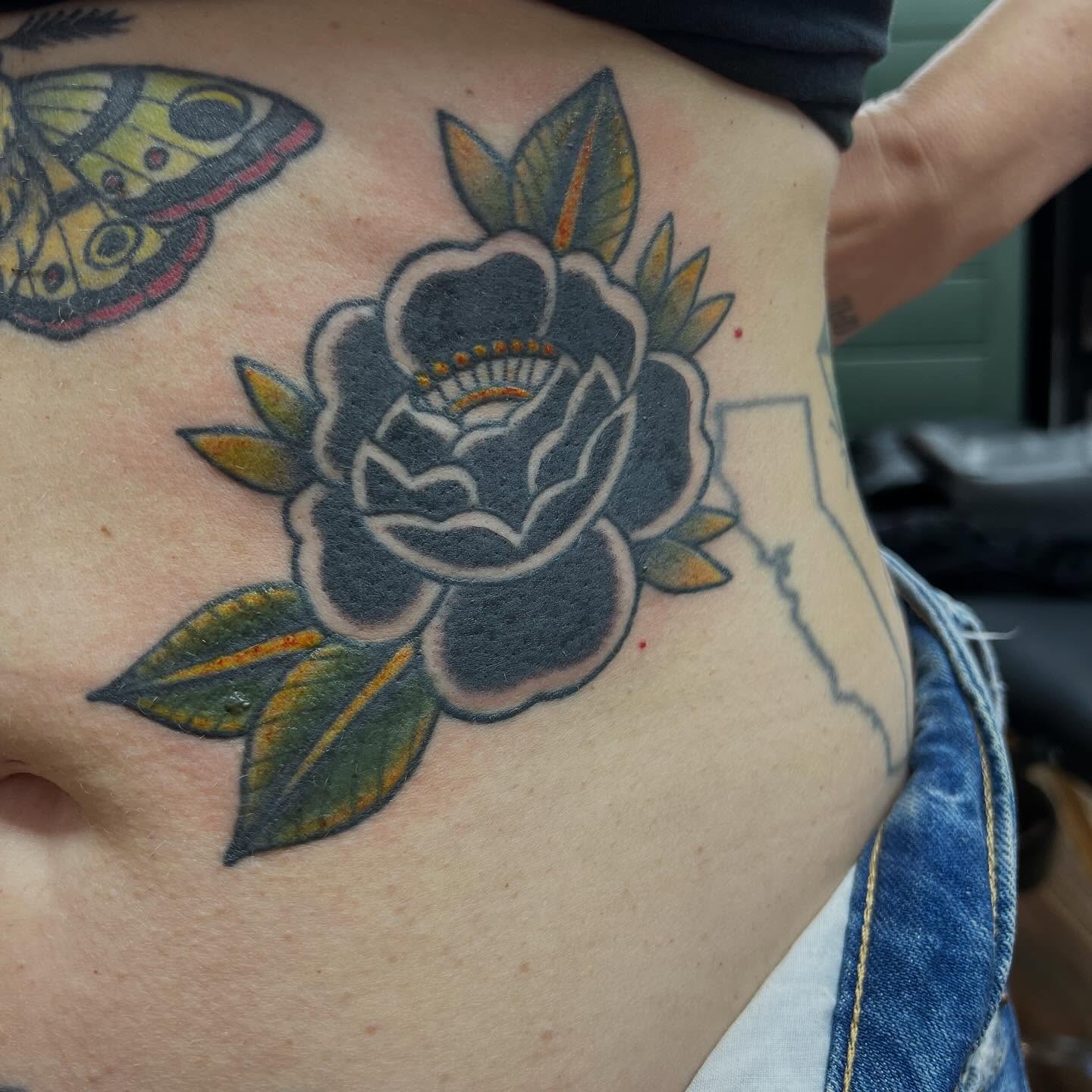Rose American traditional tattoo on the ribs by Victorian Coleman