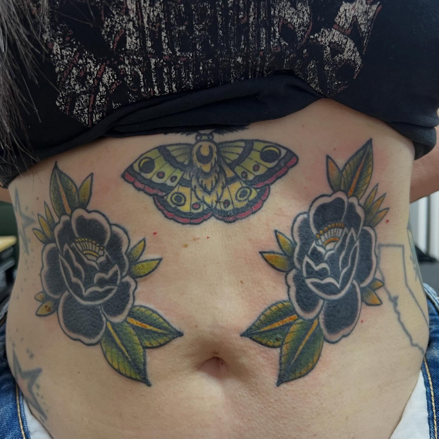 Butterfly and roses American traditional tattoo on the torso by Victorian Coleman